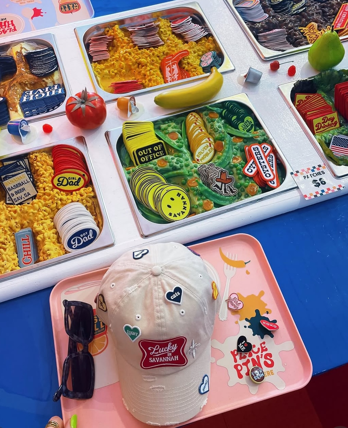A colorful patch bar in a nostalgia cafeteria setting. Baseball cap on display with patches, showcasing customization.