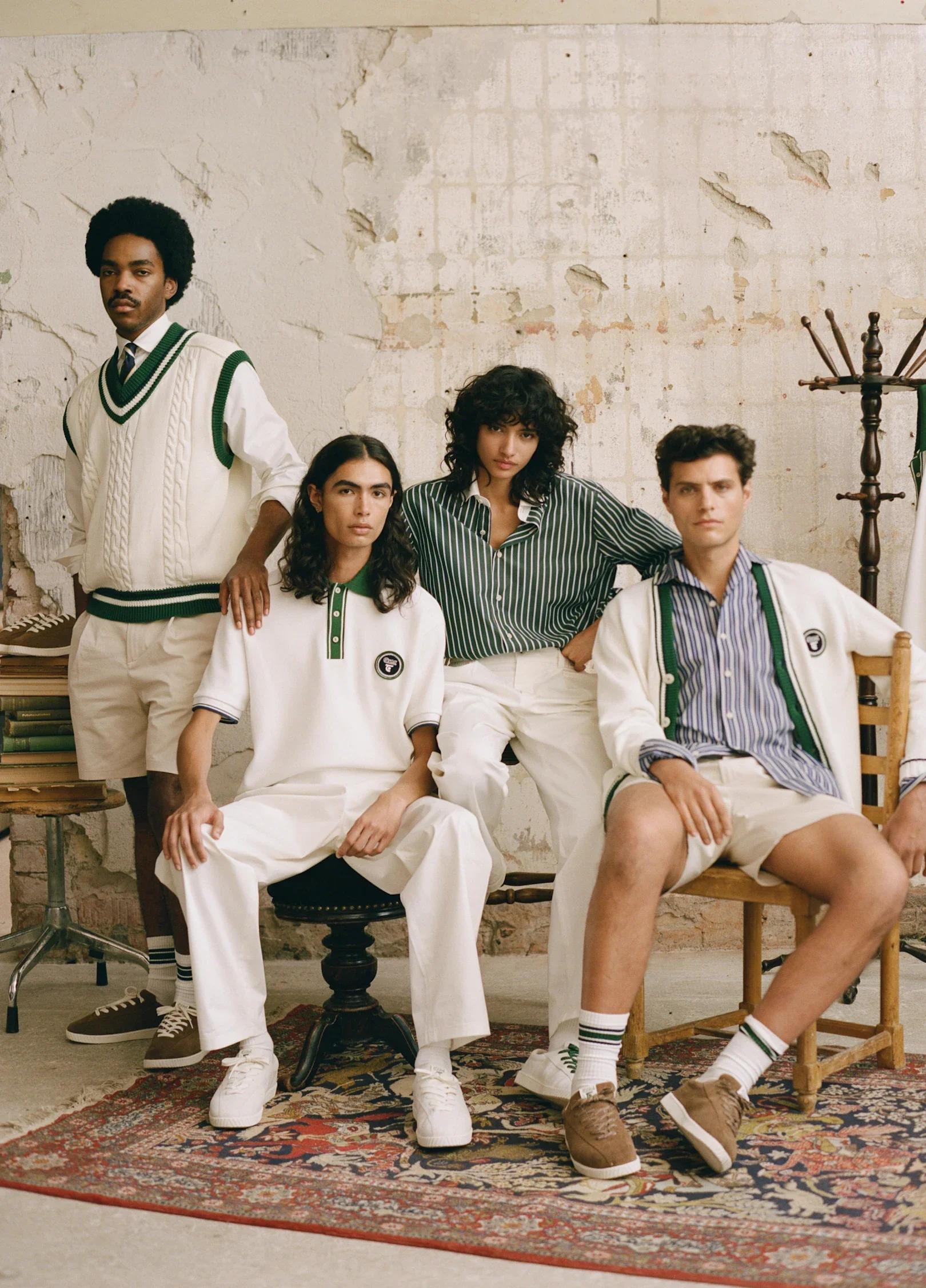 Group of 4 models sporting green and white prep clothing like vests and button ups.