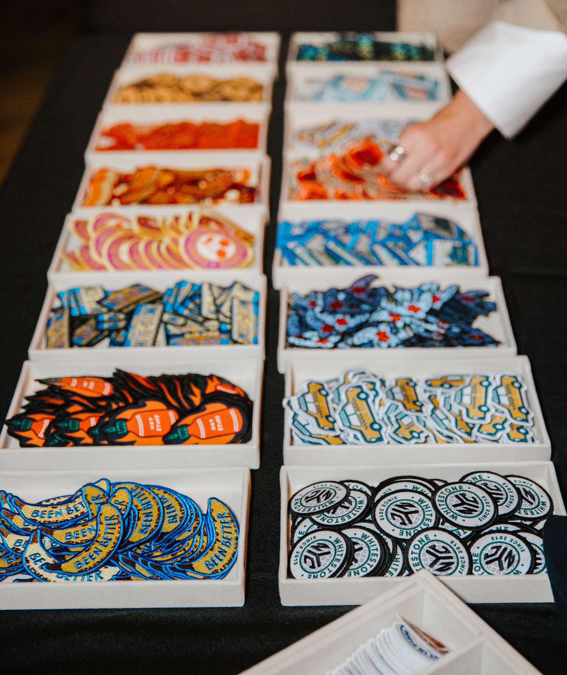 Array of colorful patches at an onsite activation intended for heat press-decoration, showcasing personalization and customization.