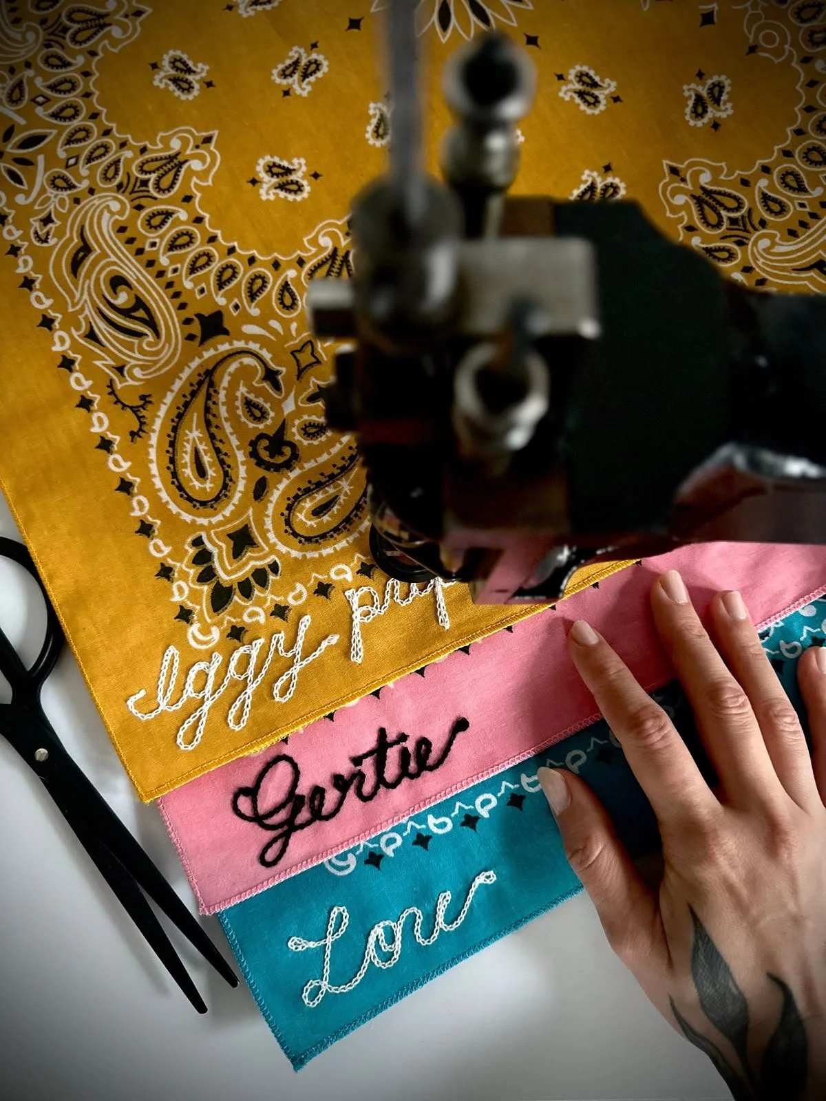 Stack of 3 colorful bandanas featuring chain stitch customization from an embroidery machine, offering an unforgettable onsite experience in minutes.