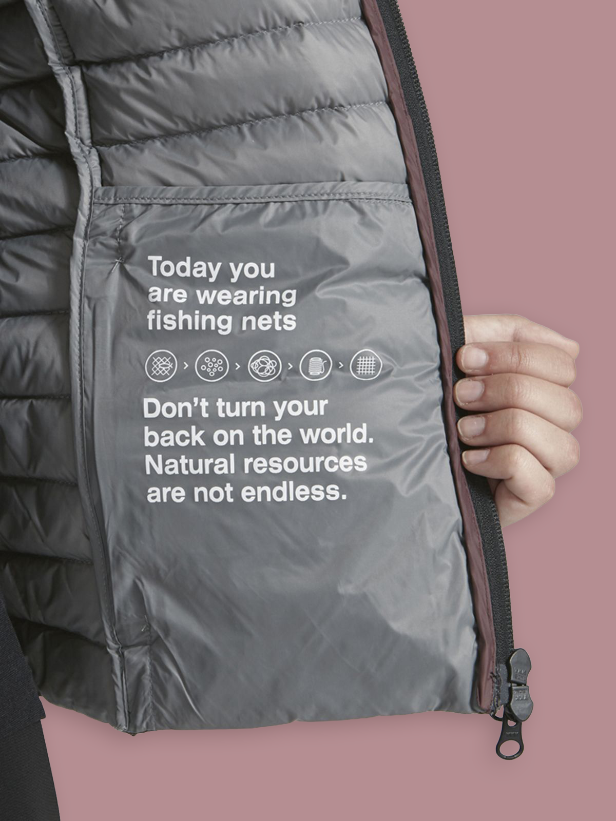 acket made from recycled fishing nets with text reading "don't turn your back on the world, natural resources are not endless," demonstrating environmental messaging and sustainable materials.