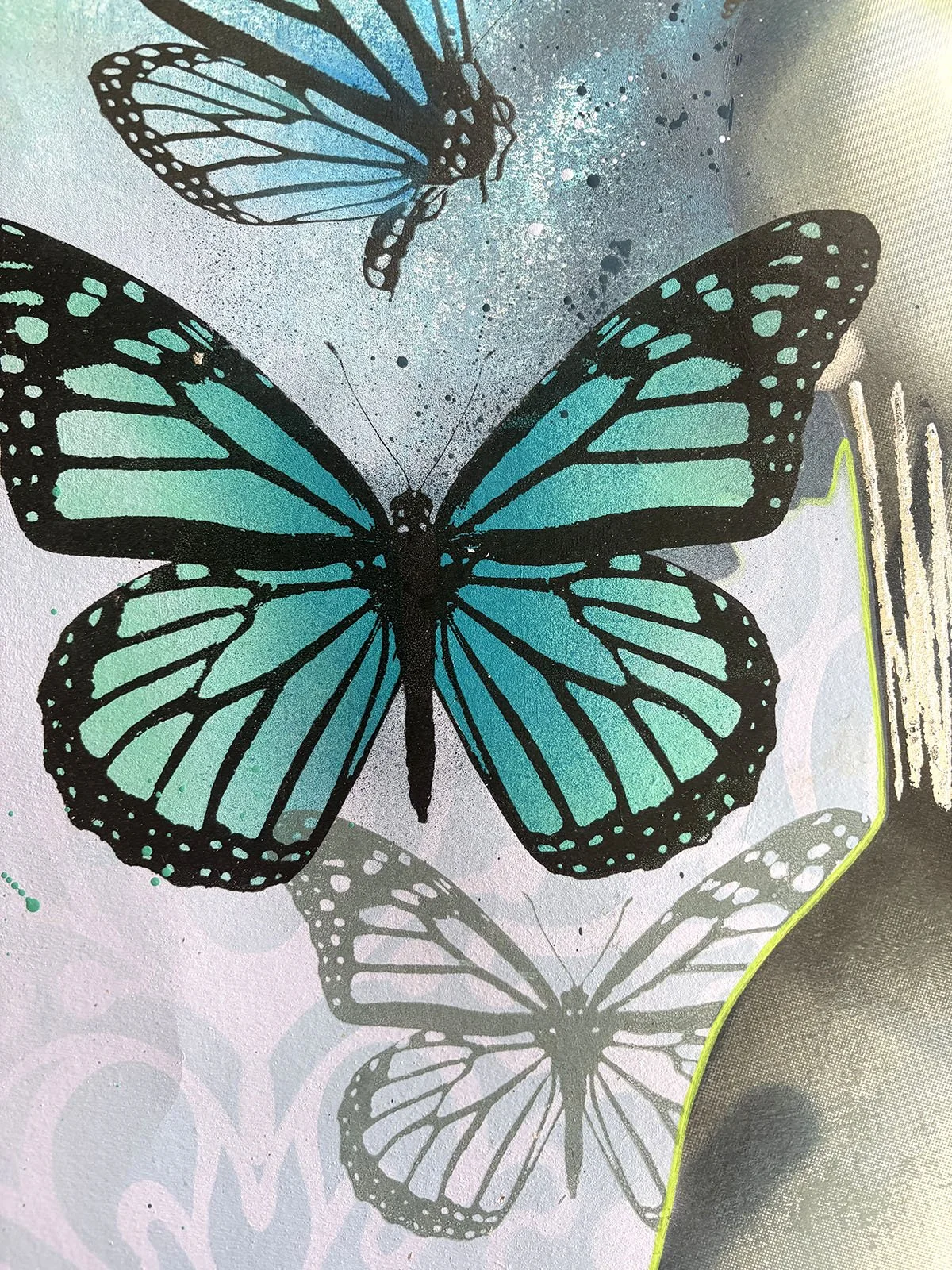 Illustration of blue and black butterflies with wings spread, against a background with splattered paint and shadowed butterfly images.