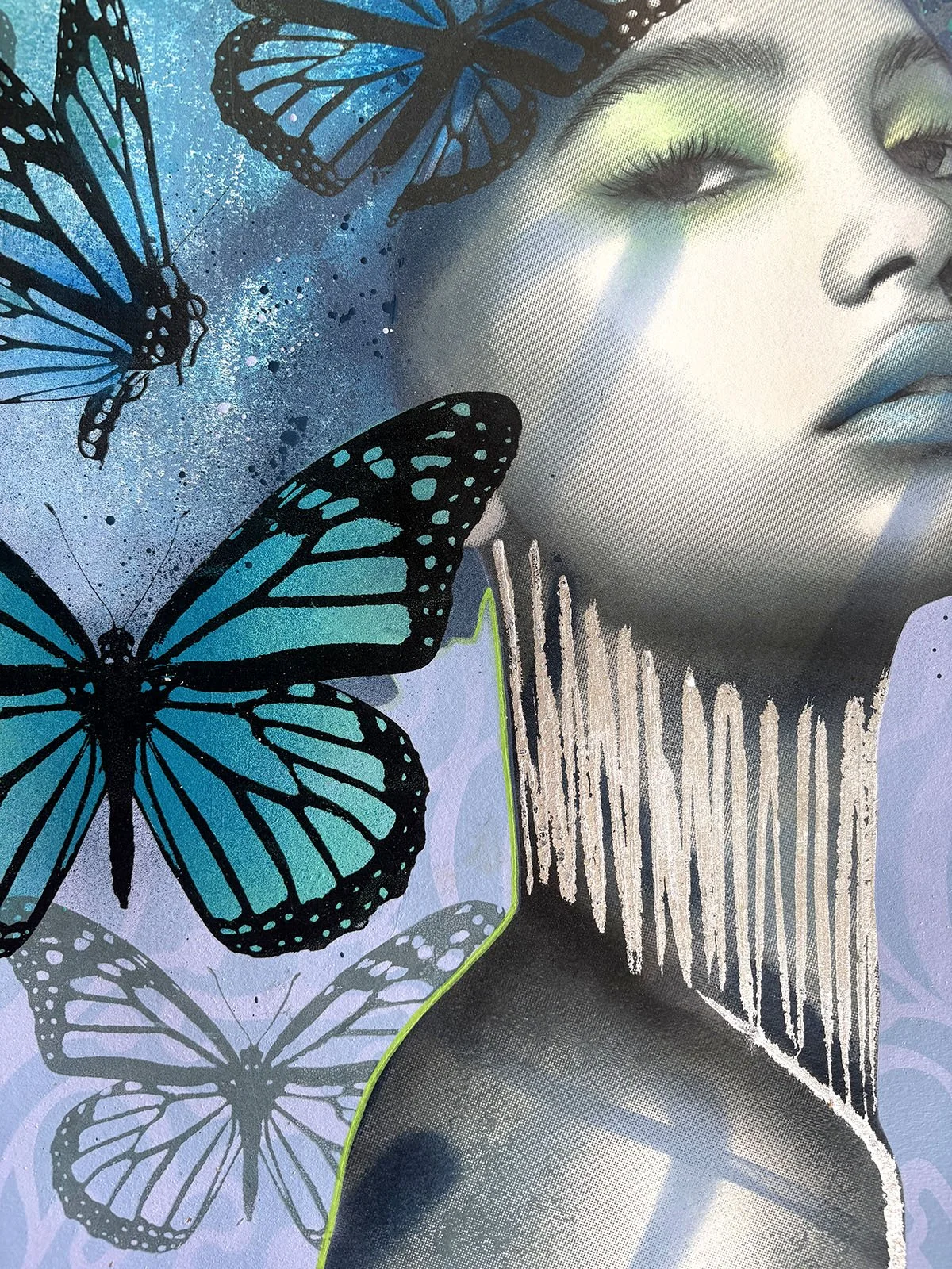 Mixed media artwork featuring a grayscale woman with butterflies in shades of blue and black, and abstract paint splatters.