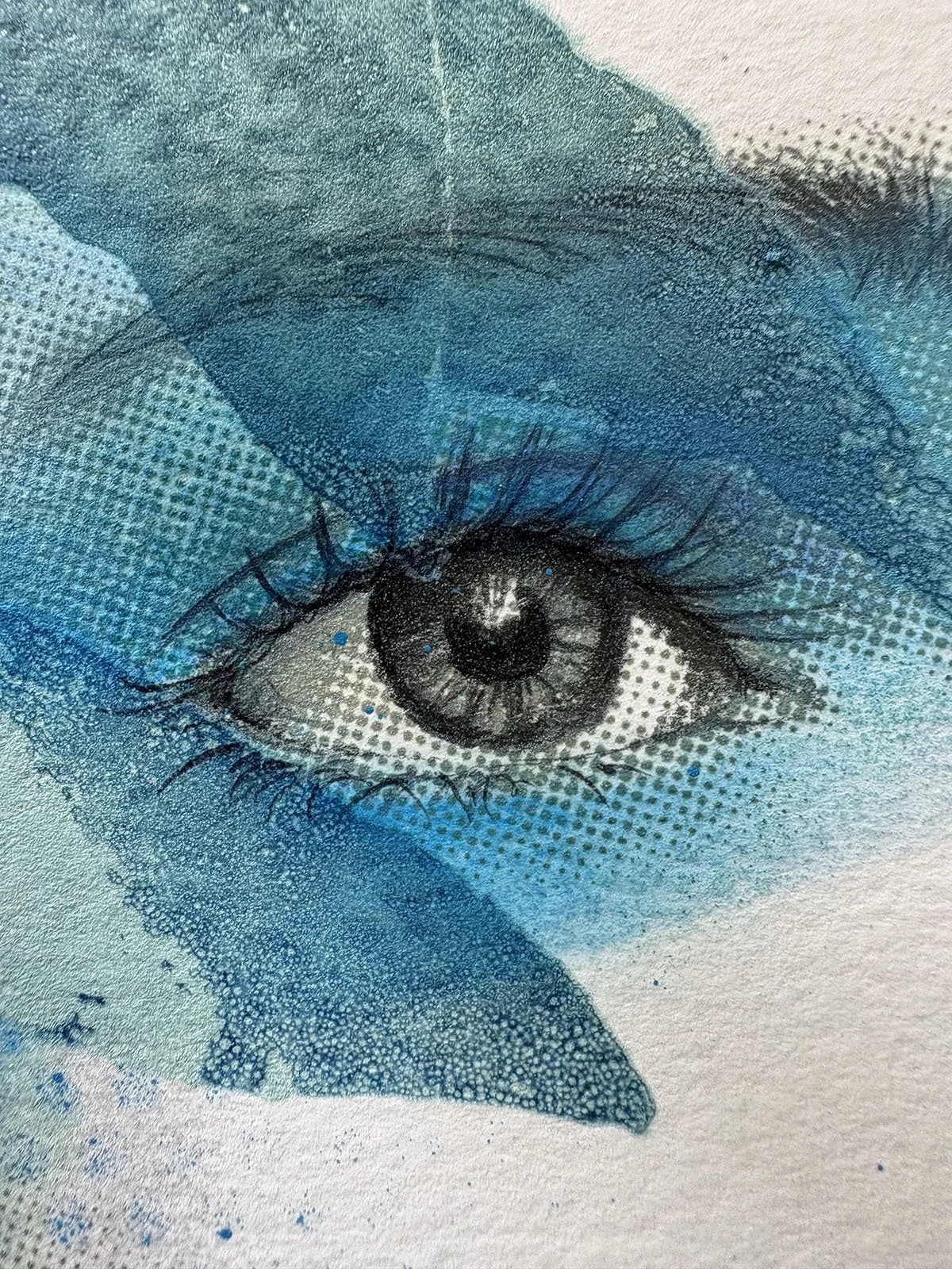 Close-up of a detailed drawing of a human eye with blue watercolor accents and dotted shading.