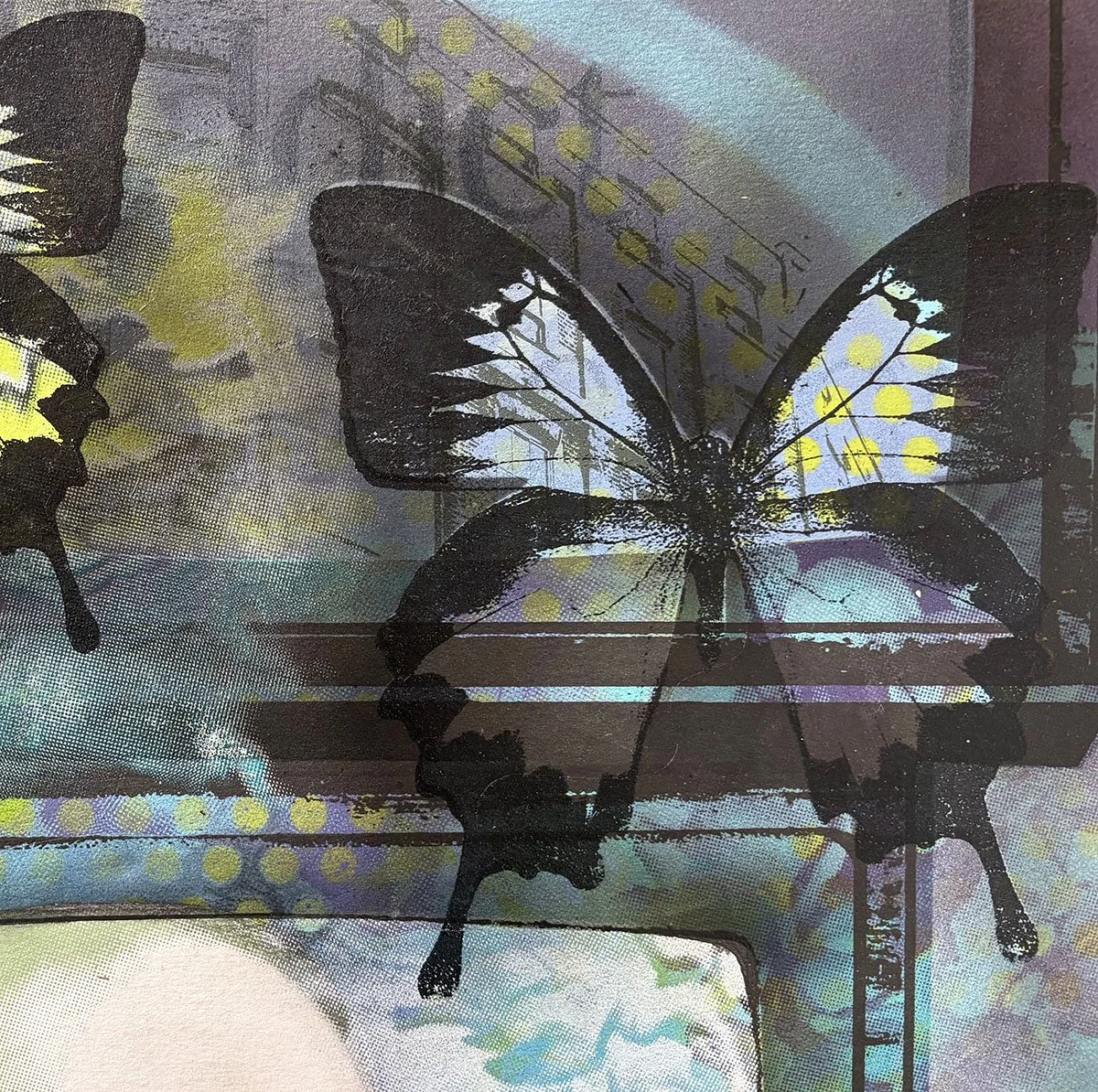 Black and white butterfly stencil art with yellow and white spots on a colorful, abstract digital background.