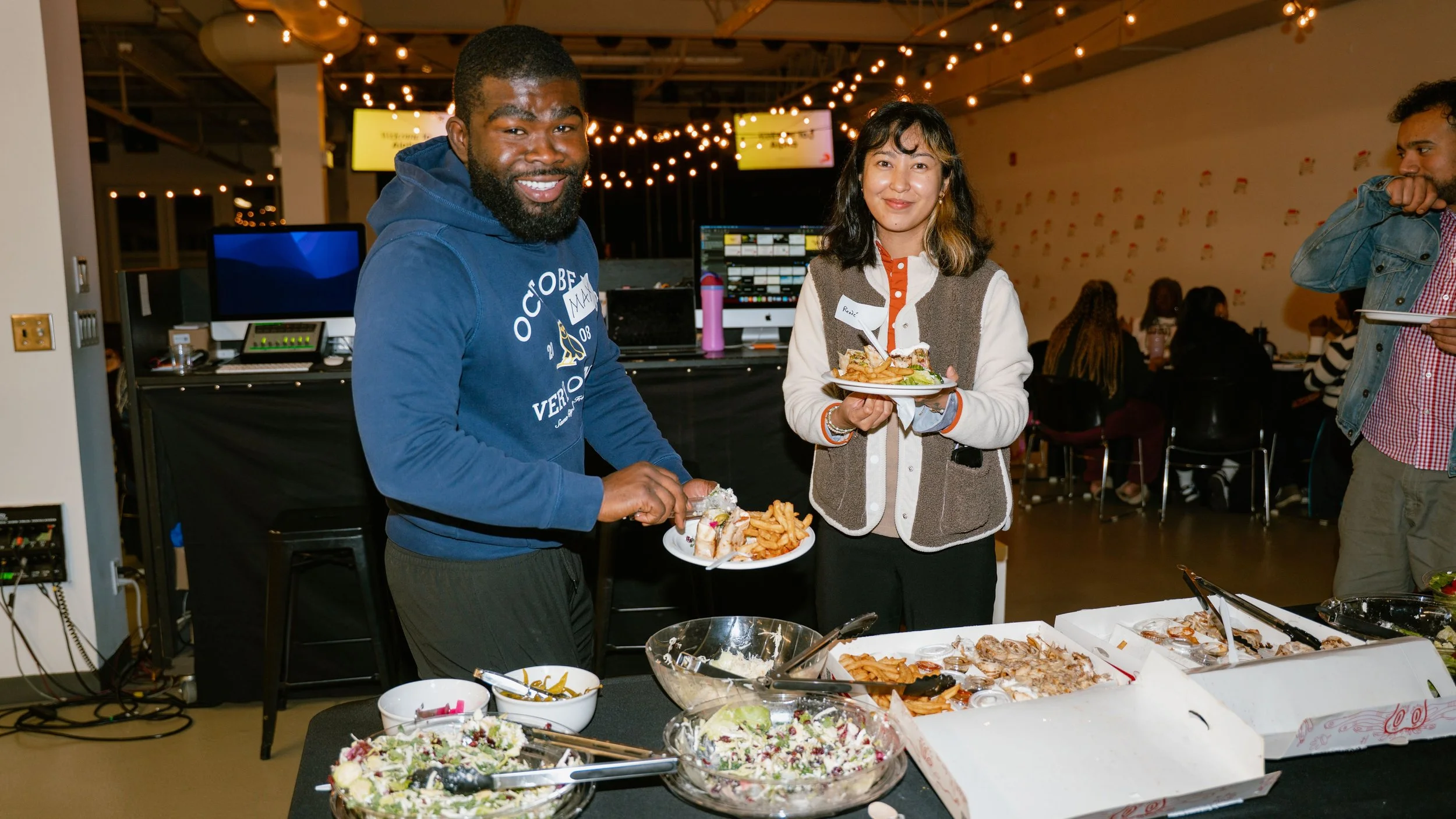 People smiling and grabbing food