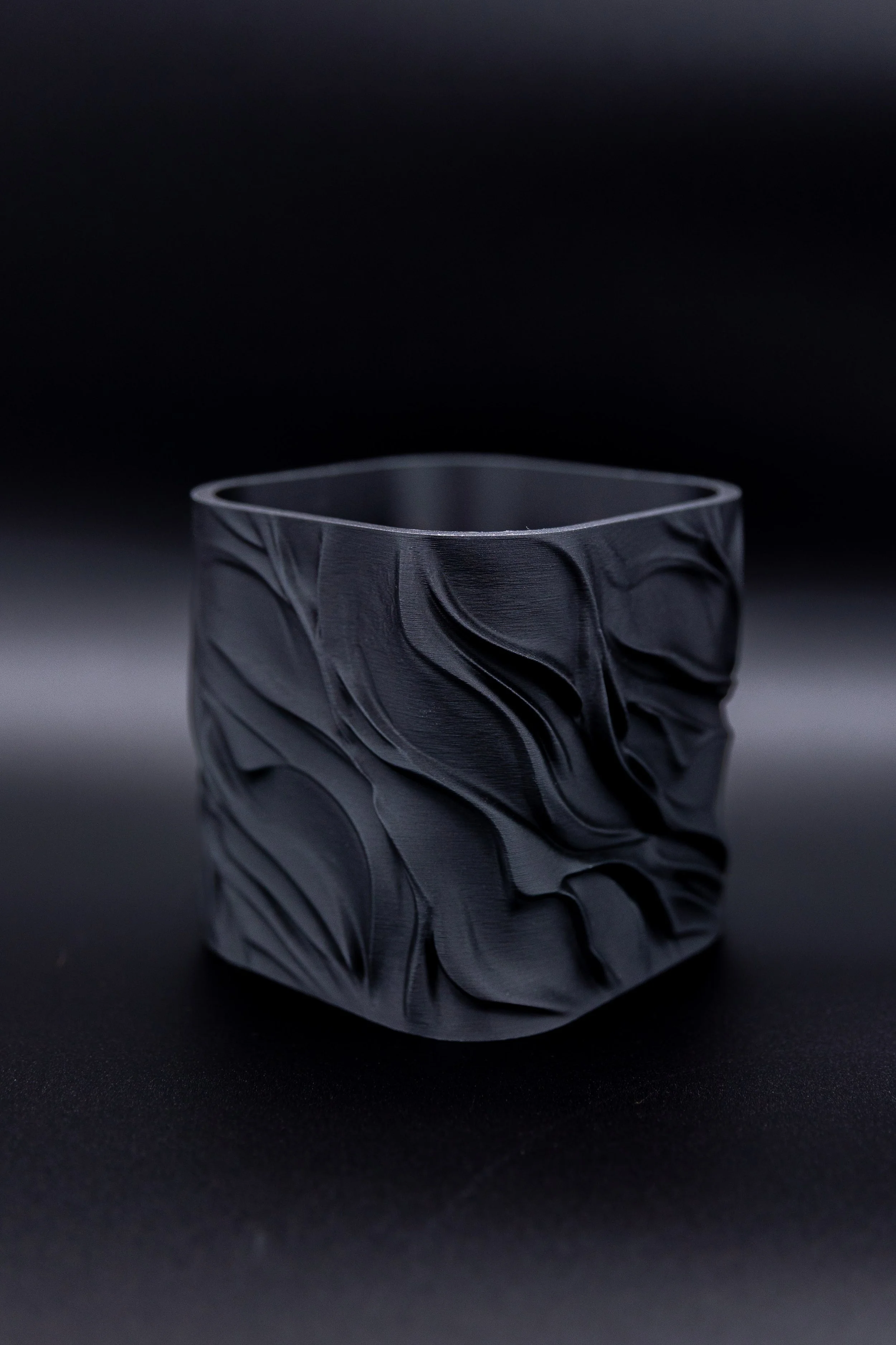 Empty KG Planter in matte black showing the square shape and flowing carved pattern.