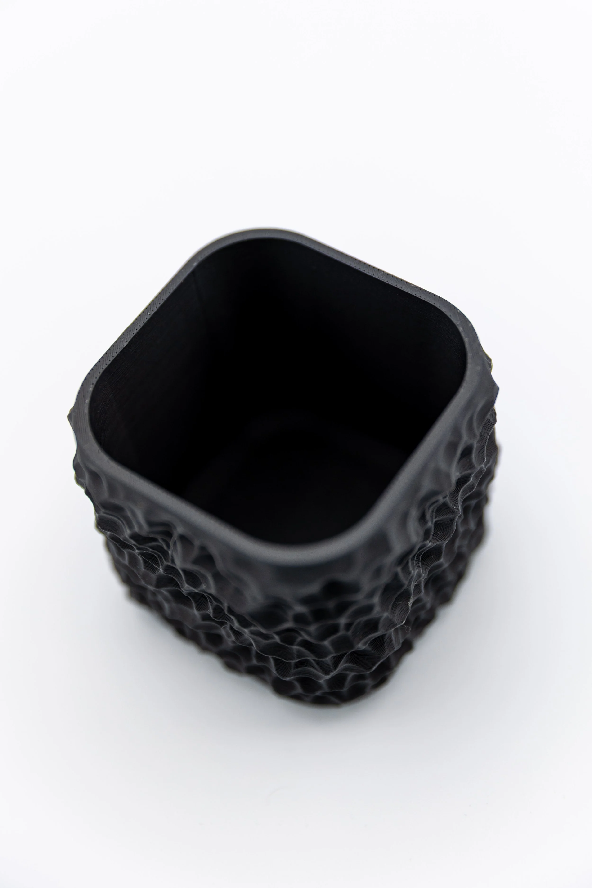 Faultline Planter top view, no-drainage decorative planter with rugged fault-line texture, black 3D printed design.