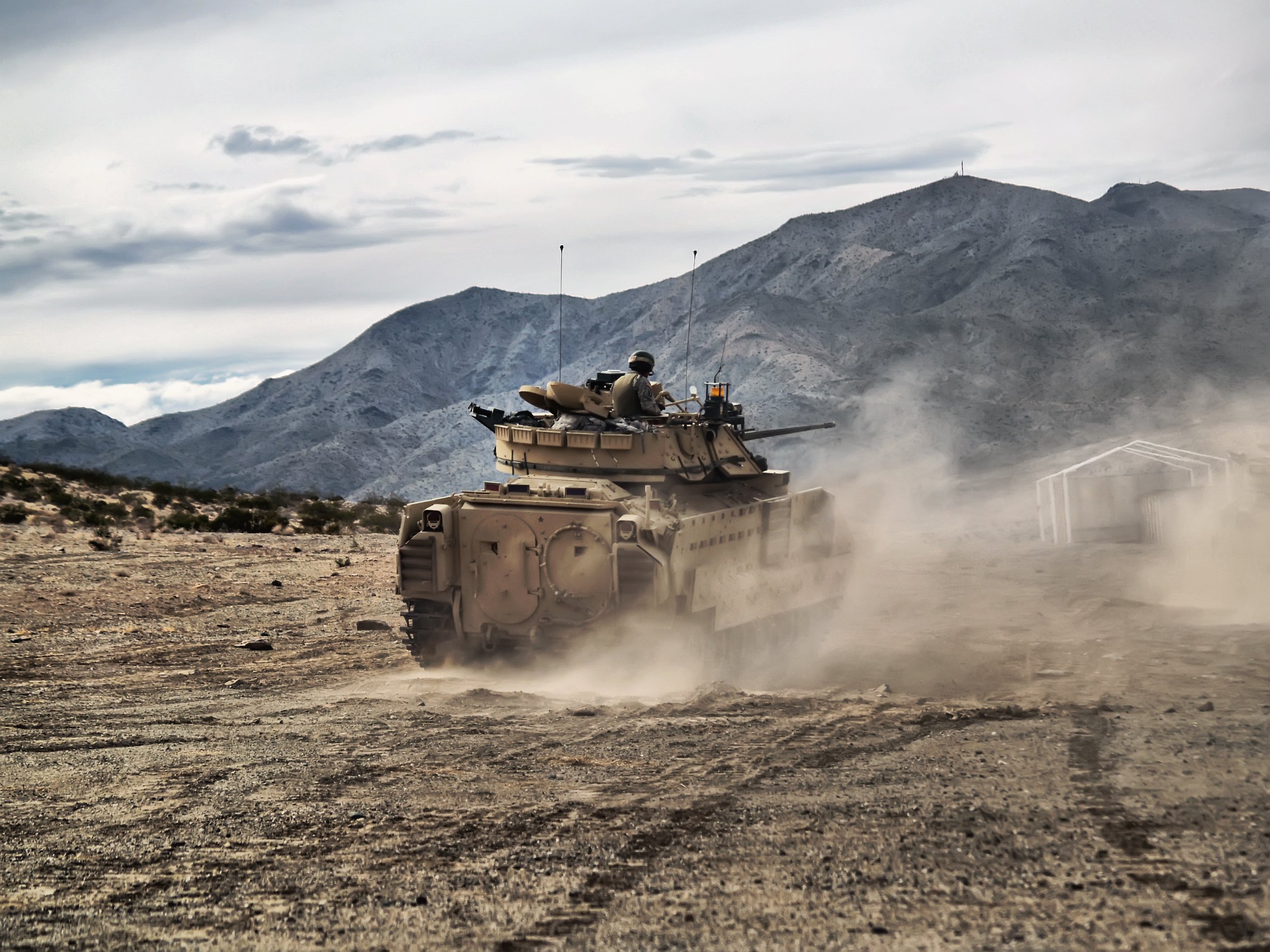 A M2A2 Bradley conducts a CALFEX Live Fire at the National Training Center, Fort Irwin California circa 2012 