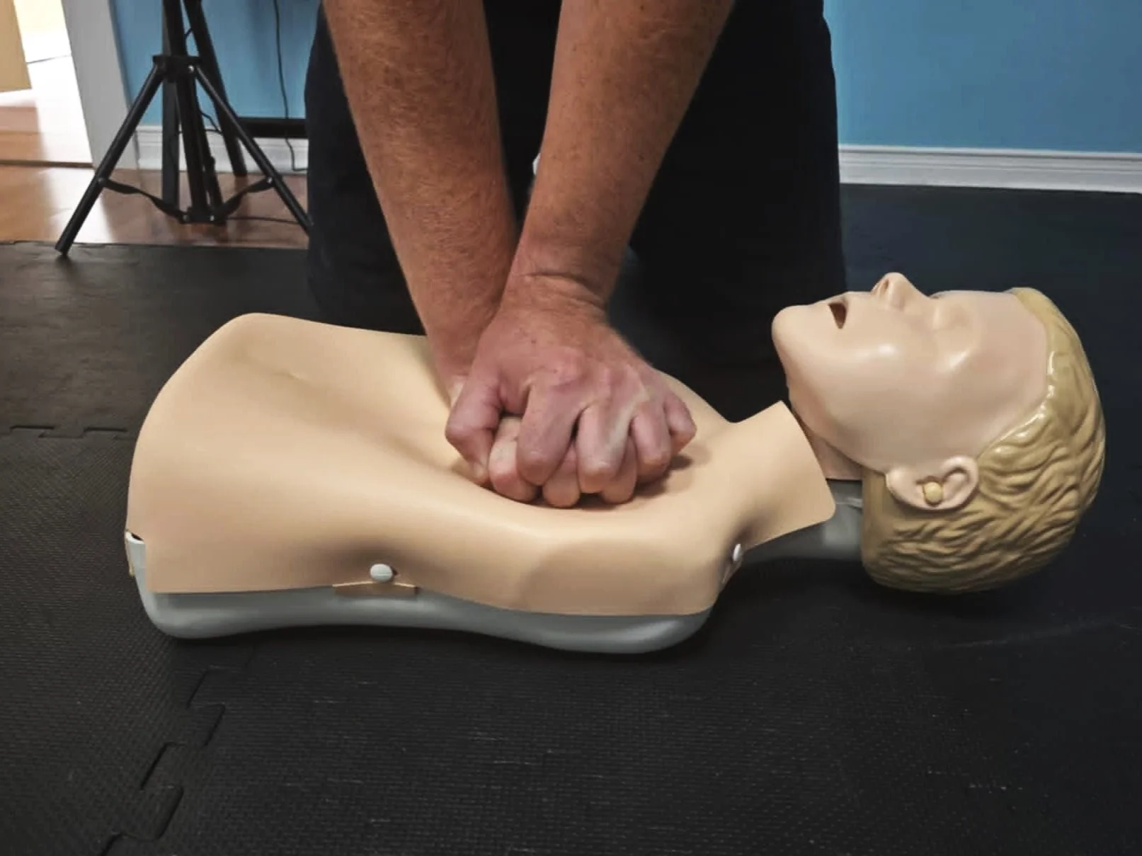 CPR training setup with AED and first aid supplies in a classroom environment.