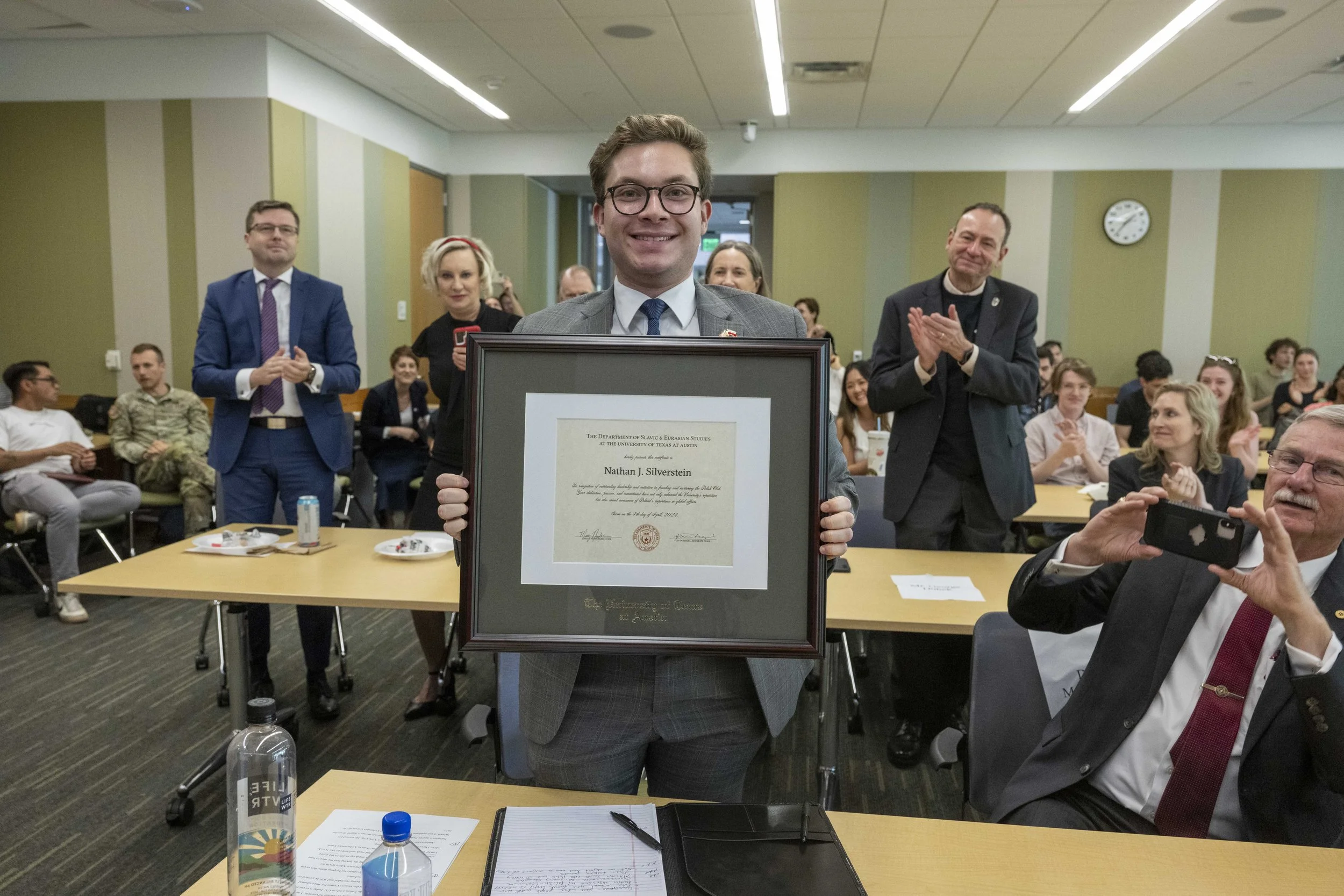 Receiving a certificate of leadership and accomplishment from the Center for Russian, East European, and Eurasian Studies.