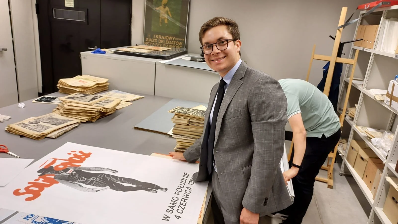 Examining original posters from Poland's 1980s anti-communist Solidarity movement at the European Solidarity Center in Gdansk, Poland.