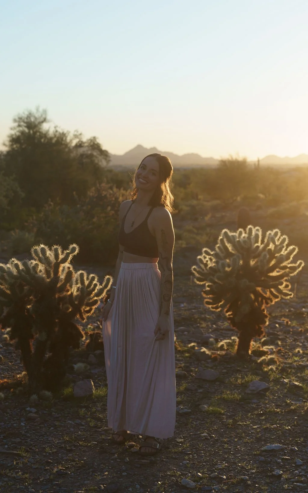 Standing smiling in desert