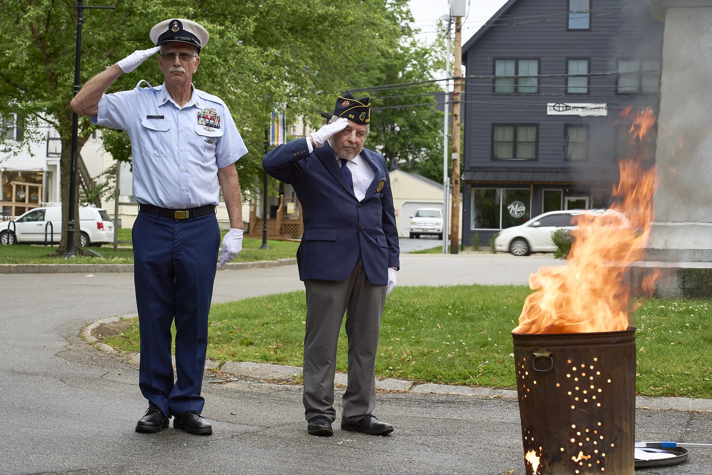 Officers of the American Legion (Post 62), Westbrook, ME, respectfully destroy unserviceable US flags on Flag Day, 2025