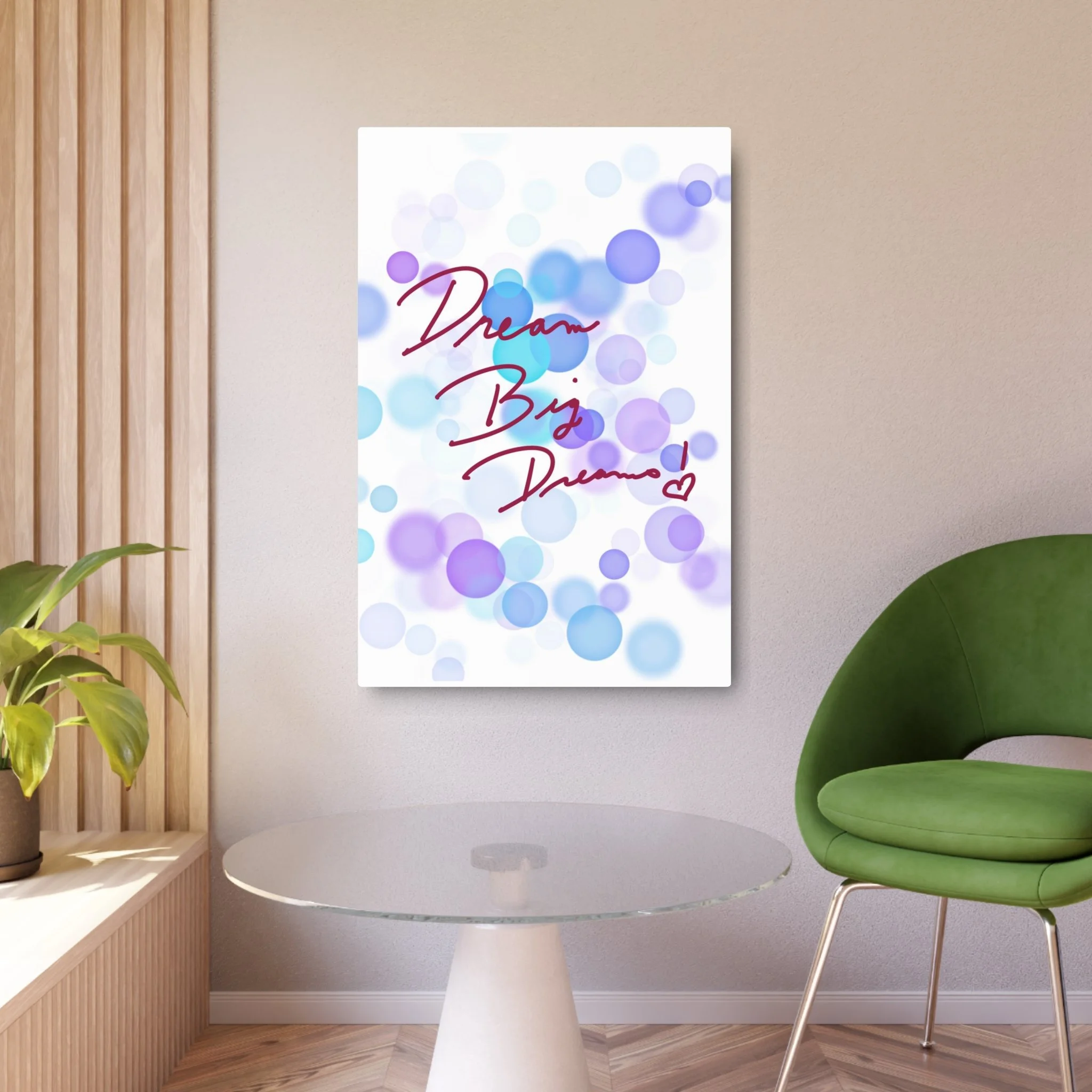 Wall art with blue and purple circles and the phrase "Dream Big Dancer" in red script, in a modern interior with a green chair, a round glass table, and a potted plant.