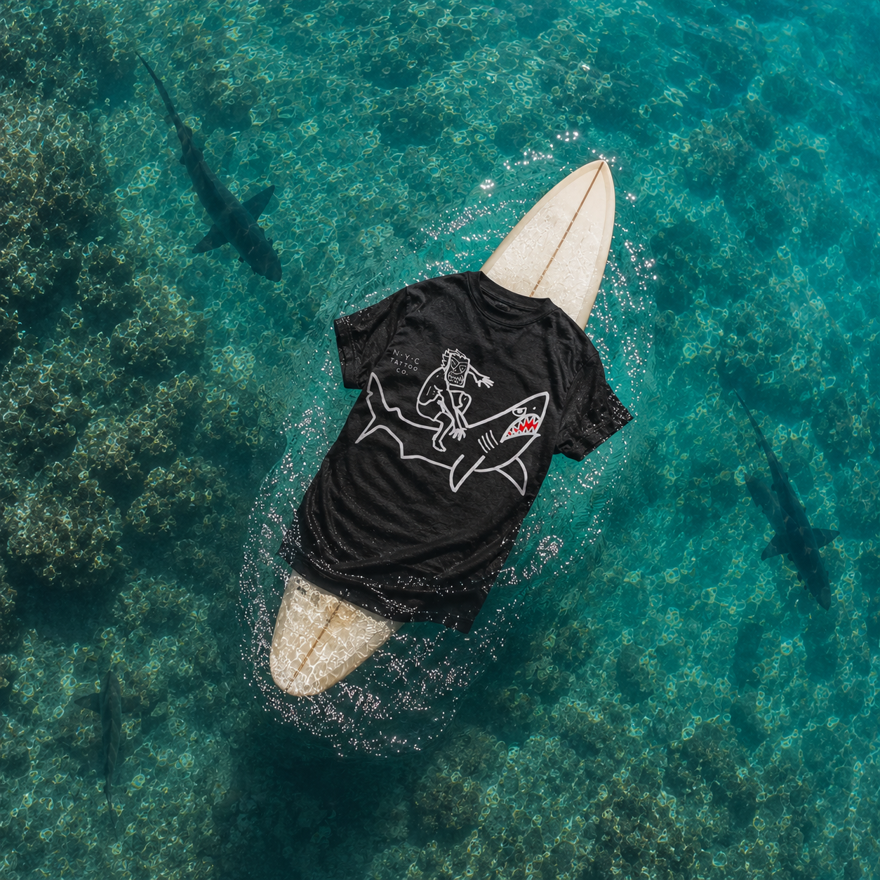 Shark rider t-shirt hawaiian style on surfboard floating in the sea
