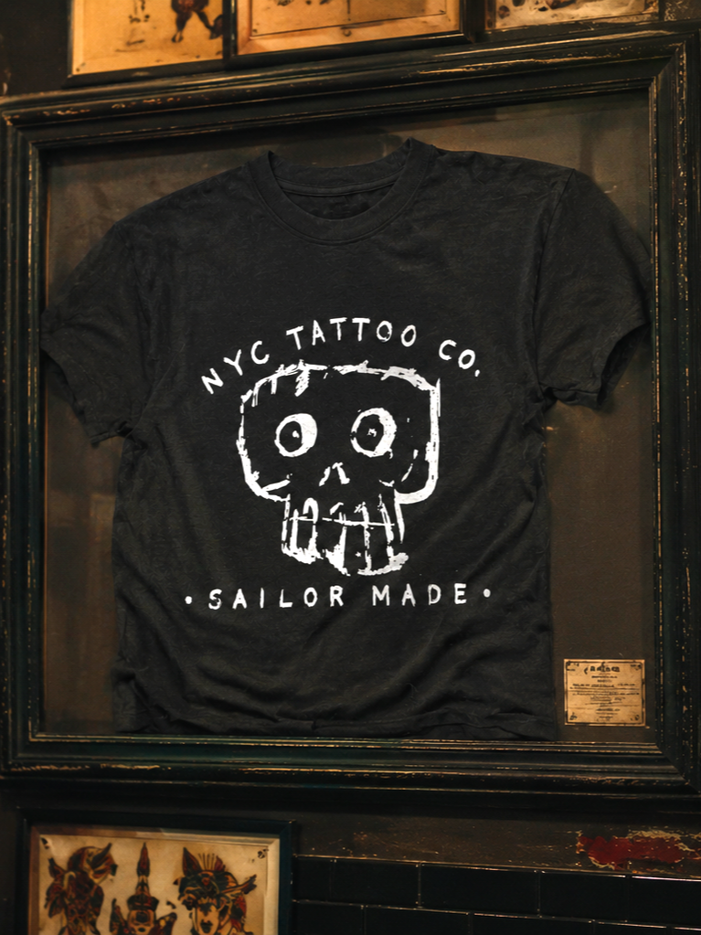 bones skull t-shirt for nyc tattoo co. hanging on wall