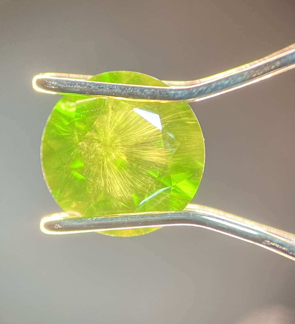 1.49ct Russian Dematoid Garnet with a textbook horsetail inclusion centered under the table.