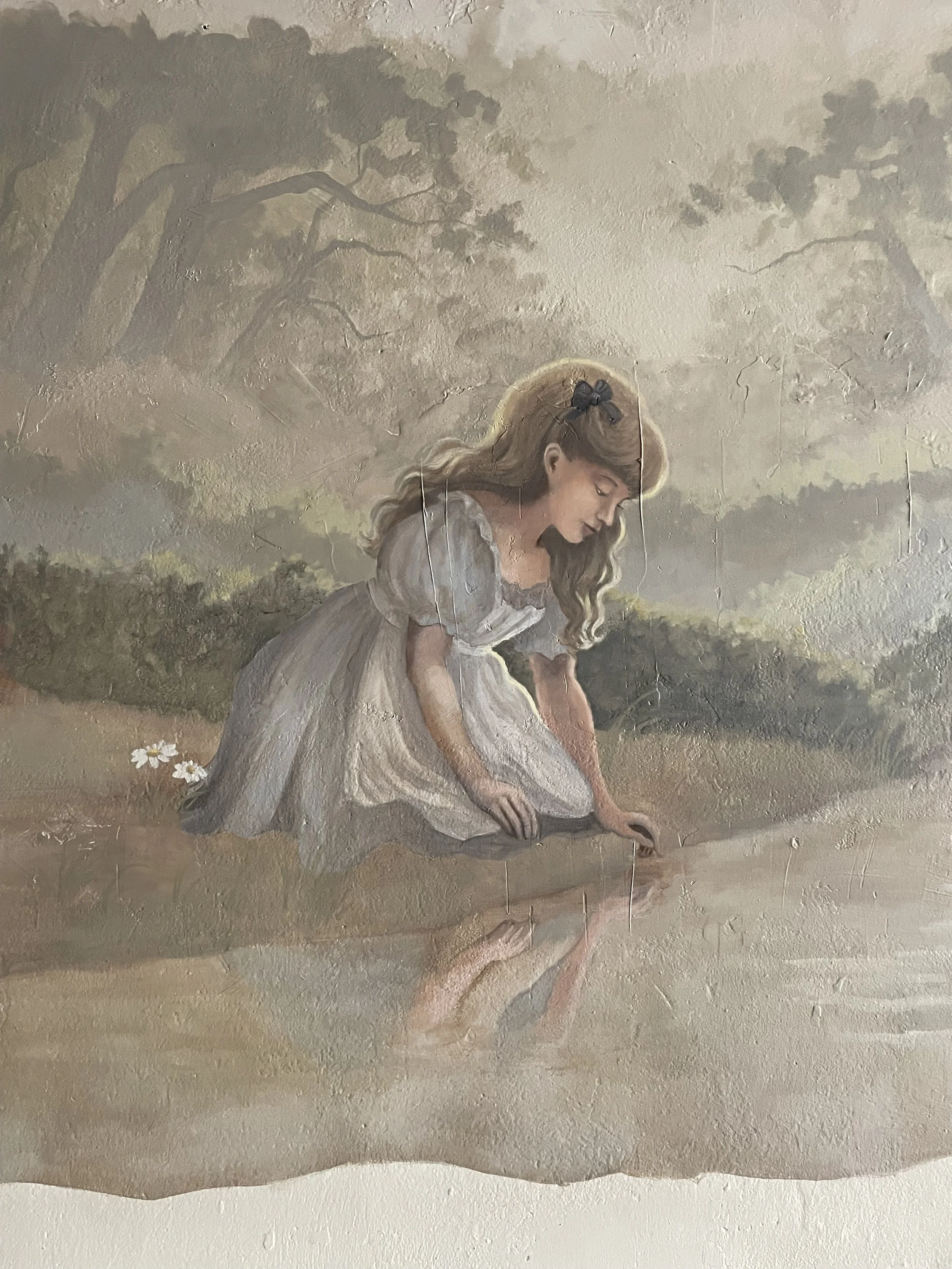 Painting of a girl with long blonde hair and a black bow, wearing a dress, sitting outdoors and touching the ground, with a landscape of trees and a cloudy sky in the background.