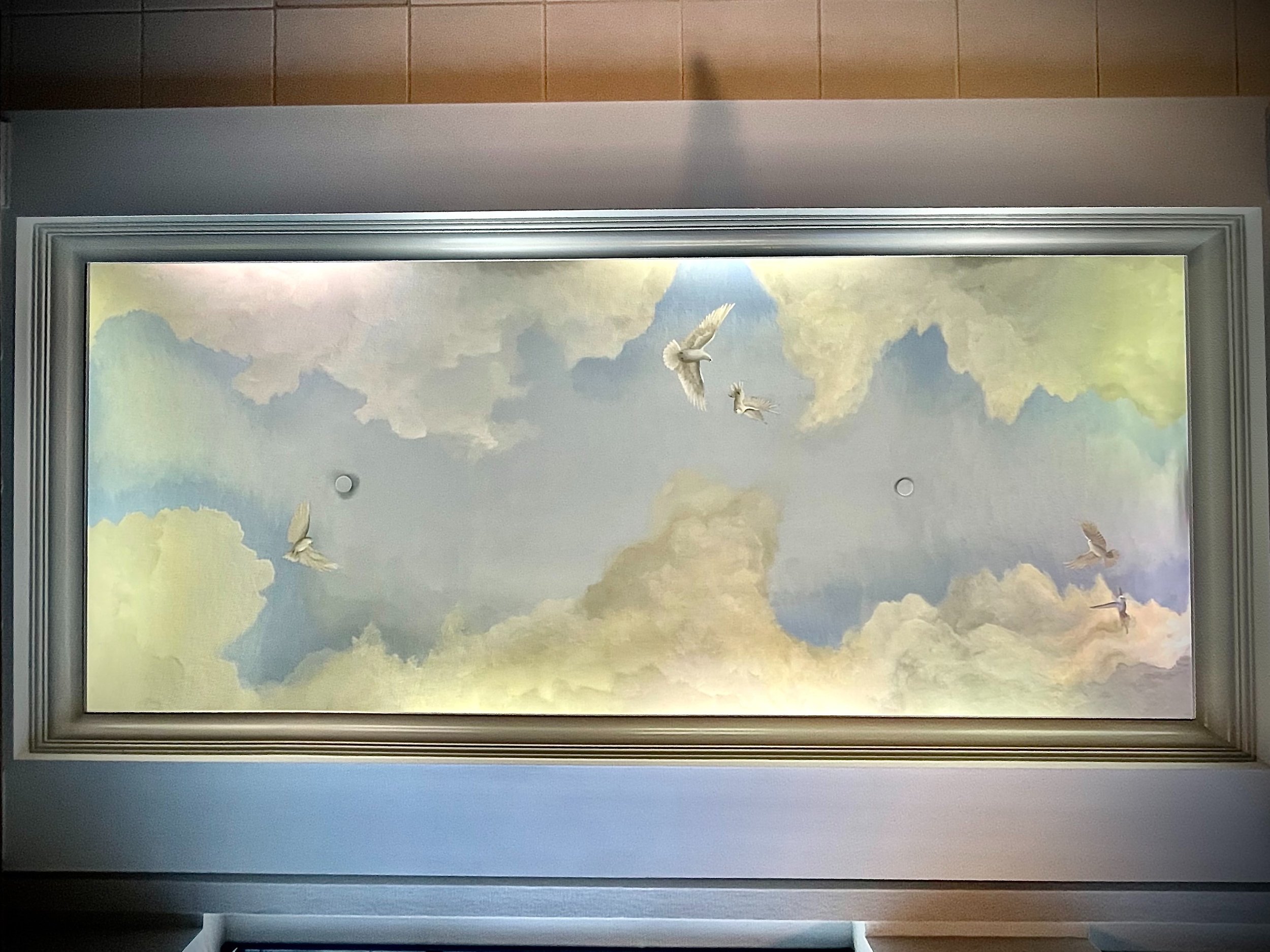 Fine art ceiling mural of blue sky with clouds and two flying white doves in historic downtown Charleston, SC by local classical artist Gabrielle Hasenstab