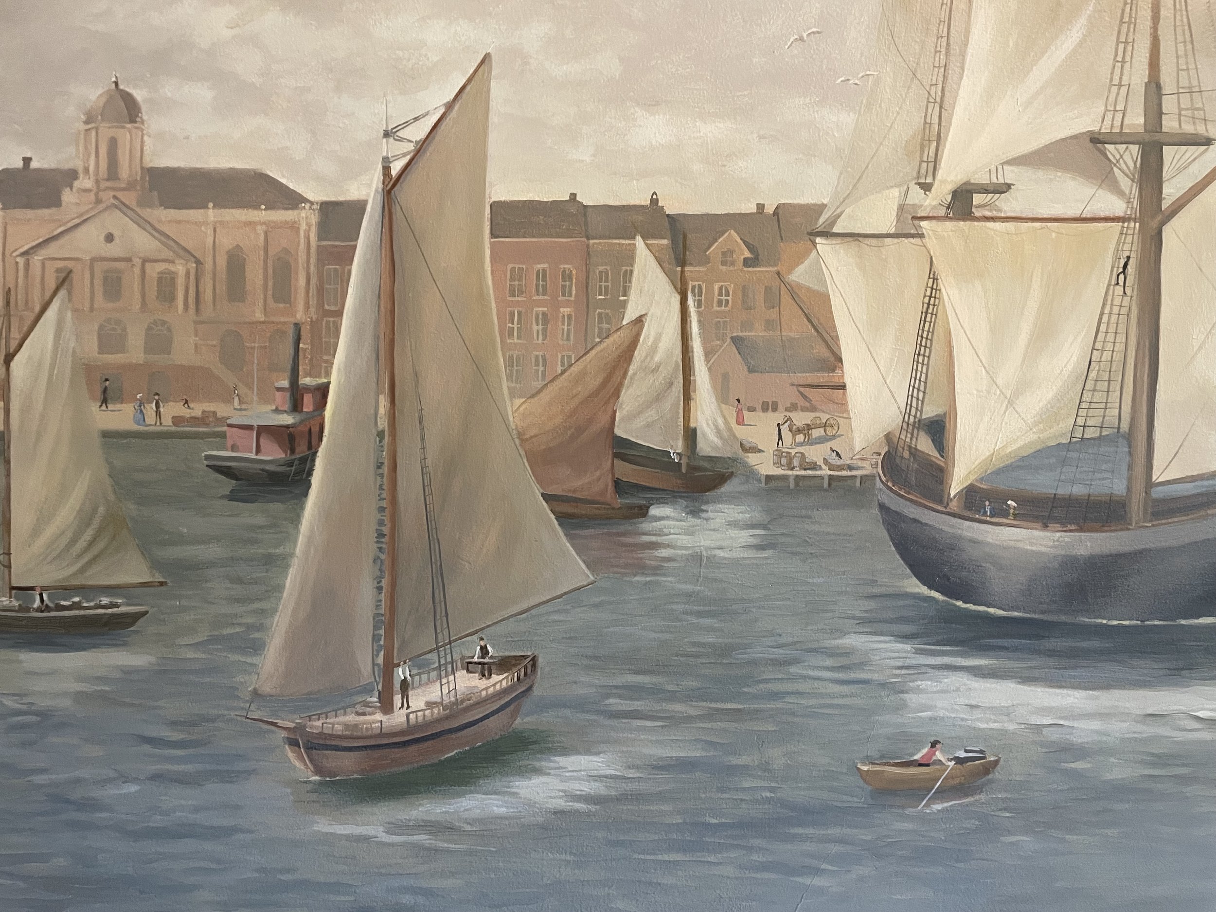 A painting of a historic Charleston harbor scene with multiple sailing ships with large white sails, and a town with old buildings in the background. Small boats and people are visible on the water and near the ships.