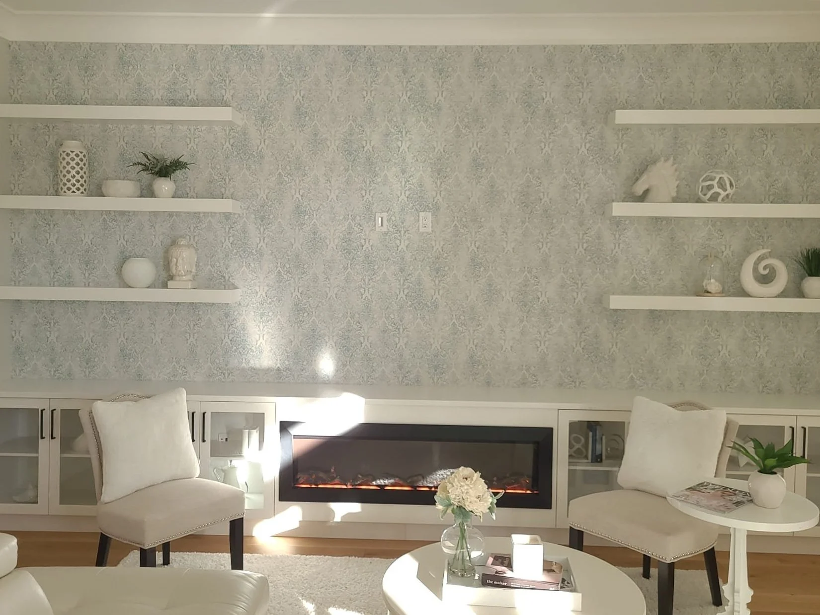 GLenhaven Contracting Ltd. kept with subtle blue accents and used a damask pattern for the family room wallpaper.