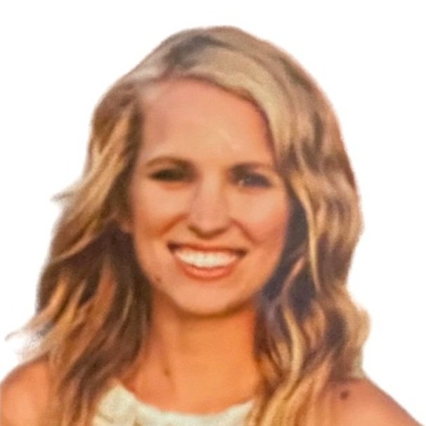 Smiling woman with wavy blonde hair against a white background.