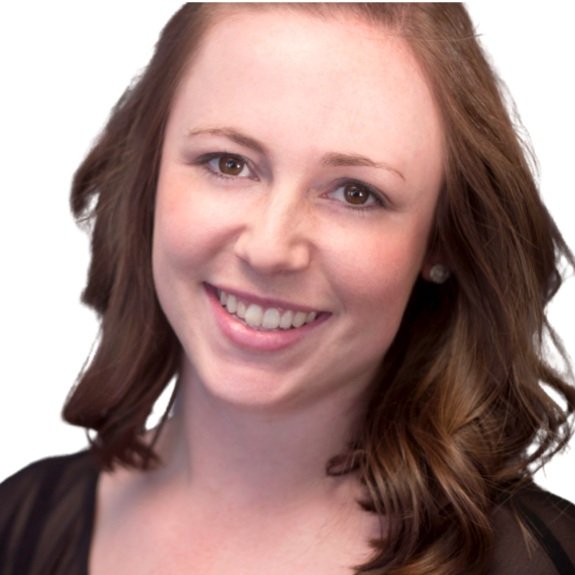 A woman with shoulder-length brown hair, smiling, wearing a black top, and small earrings, against a white background.