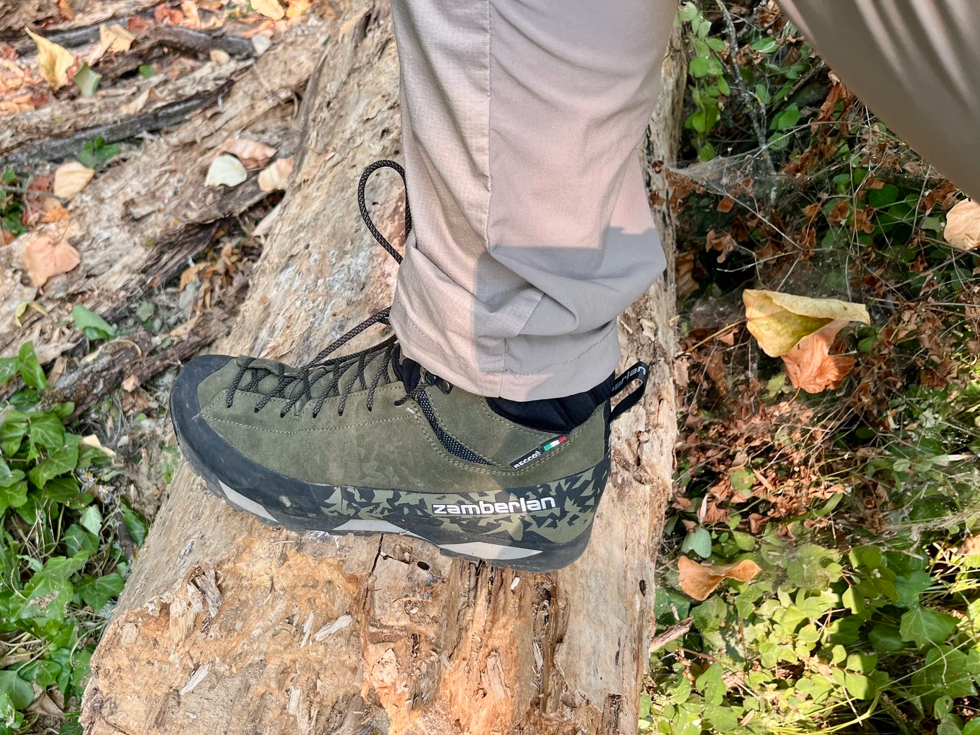 A close up shot of the Salathe Trek GTX hiking boot in geen. Wearer of the boot is standing on a log.