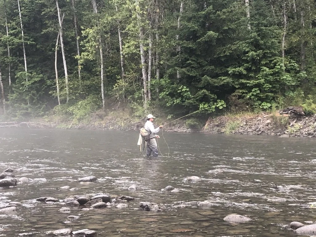 A man fly fishing in a river.