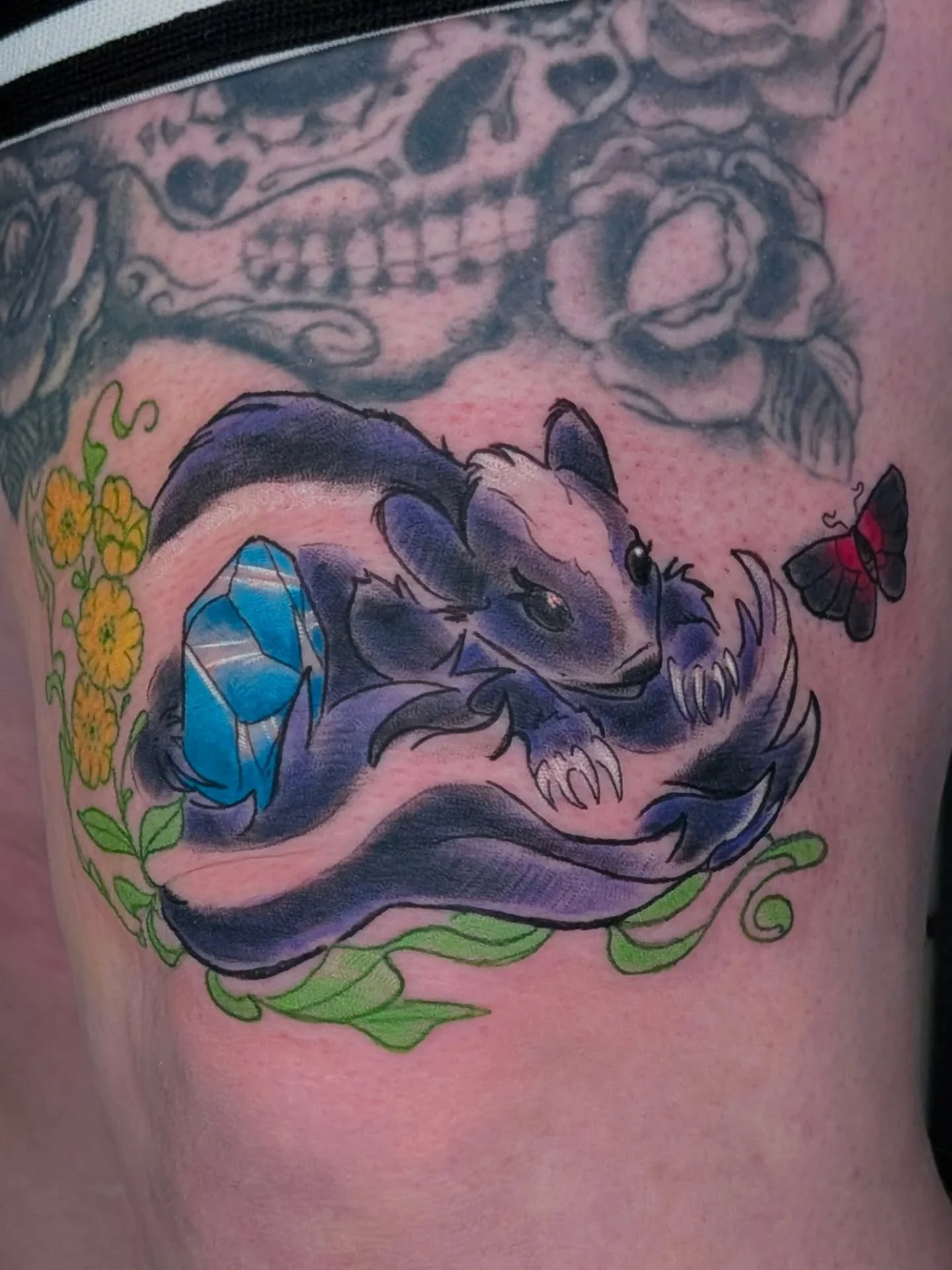 A lovely grandma memorial Skunk for Amanda. 

Right above the knee. The plan is to rework and integrate my style into the above thigh piece to match her cottagecore goth vibe. Swipe to see a mostly healed with some retouches to the berries and part o