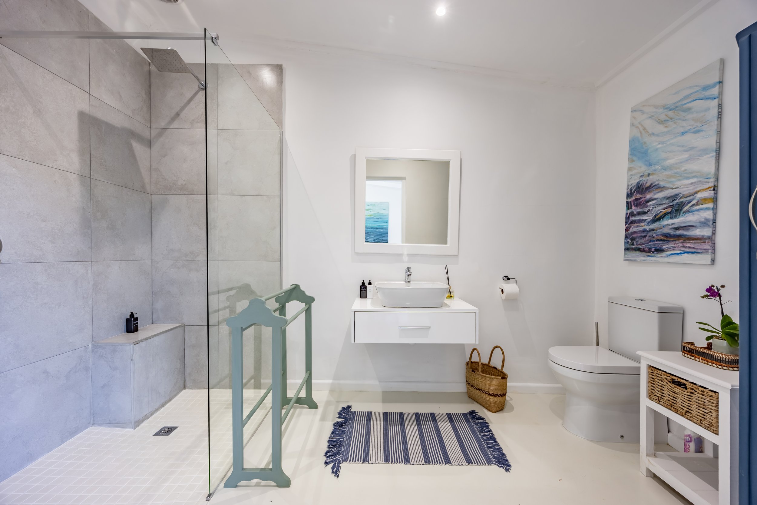 Bright modern bathroom with a walk-in shower and clean white finishes, photographed for professional residential and property marketing in Cape Town.