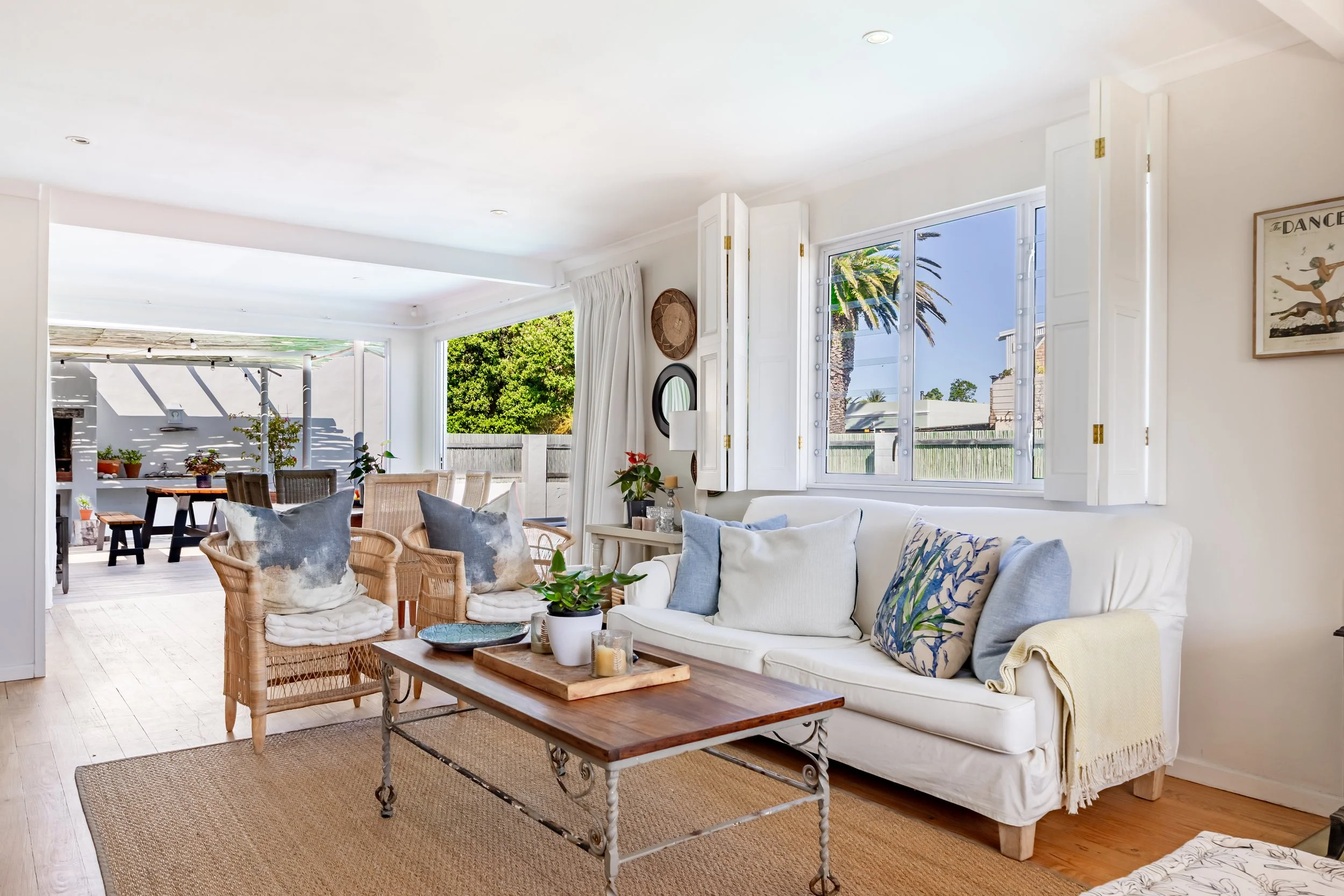 Spacious open-plan living and dining area with coastal décor and natural light, photographed for a Cape Town Airbnb property listing.