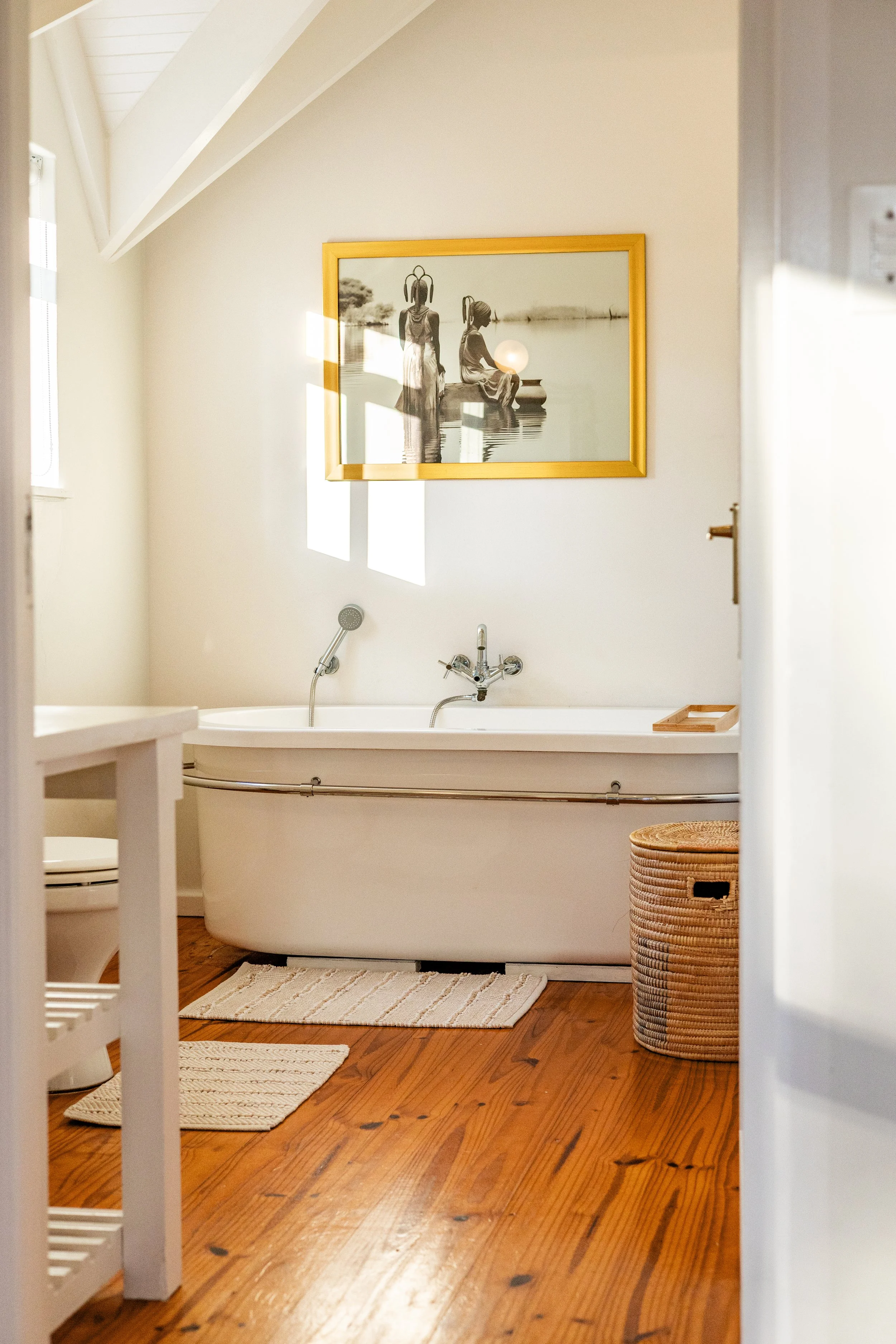 Bright freestanding bath in a modern luxury bathroom photographed for a holiday rental in Cape Town's Deep South.
