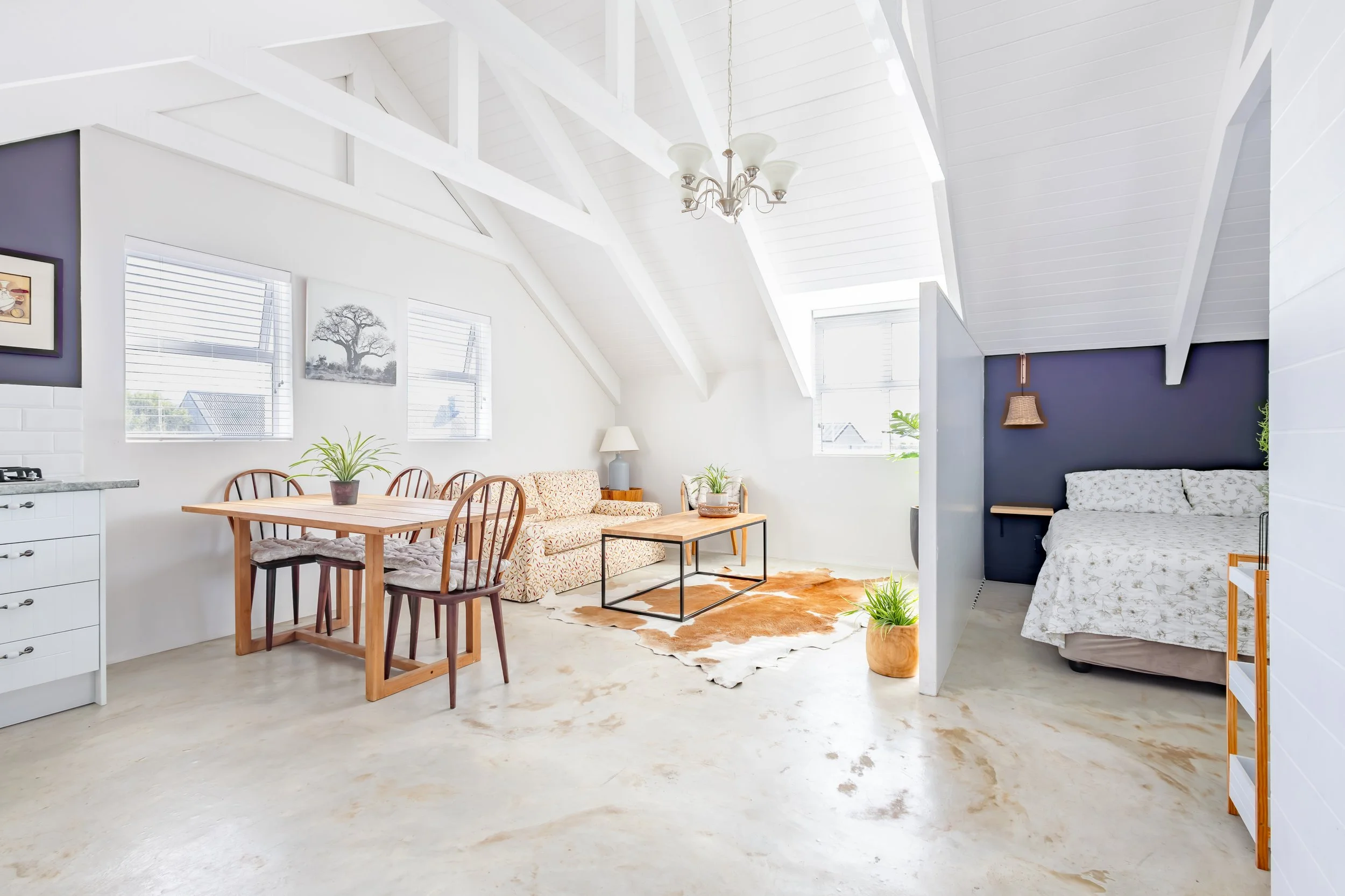 Full view of a modern loft-style apartment interior, capturing the spacious layout and natural lighting typical of high-end Airbnb photography.