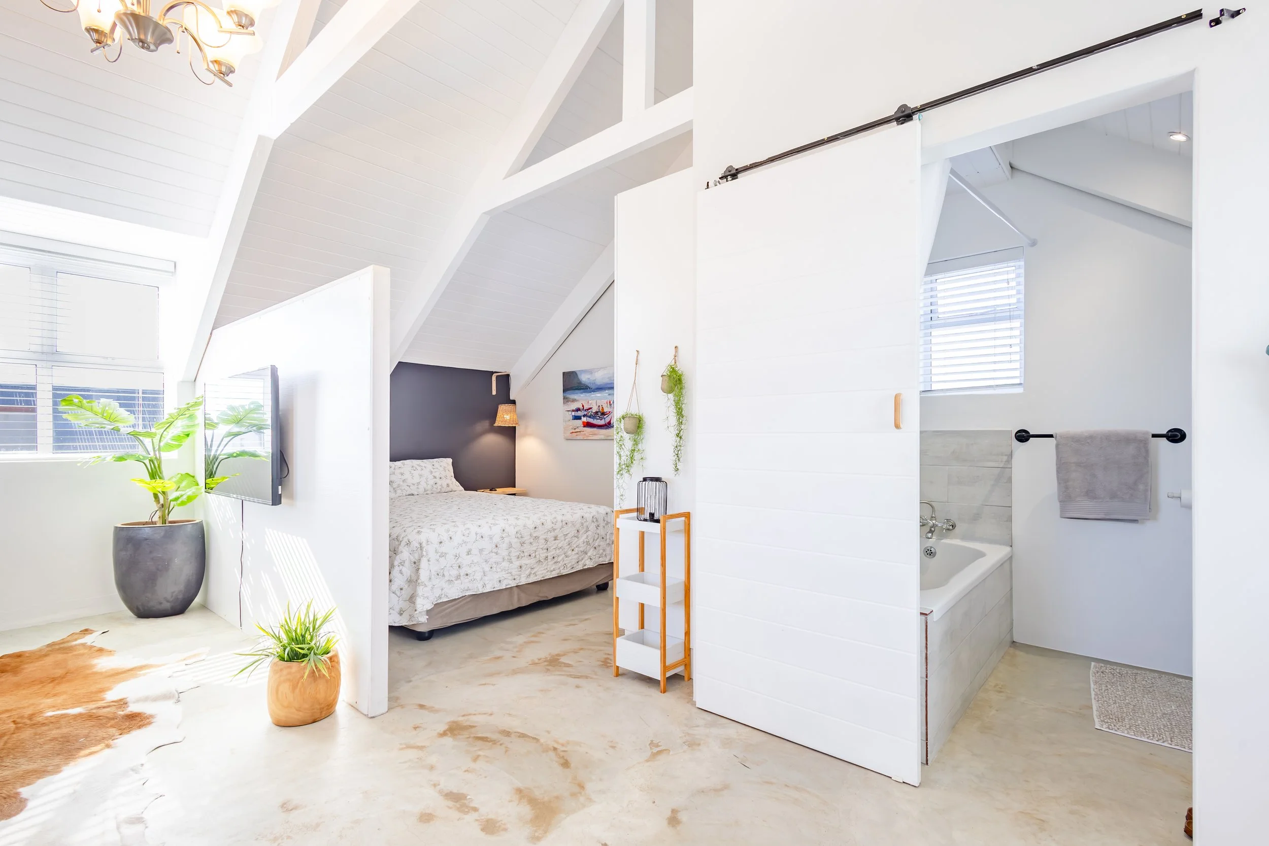 Interior view of a master suite in a Cape Town rental, showcasing the en-suite bathroom transition and bright, airy design.