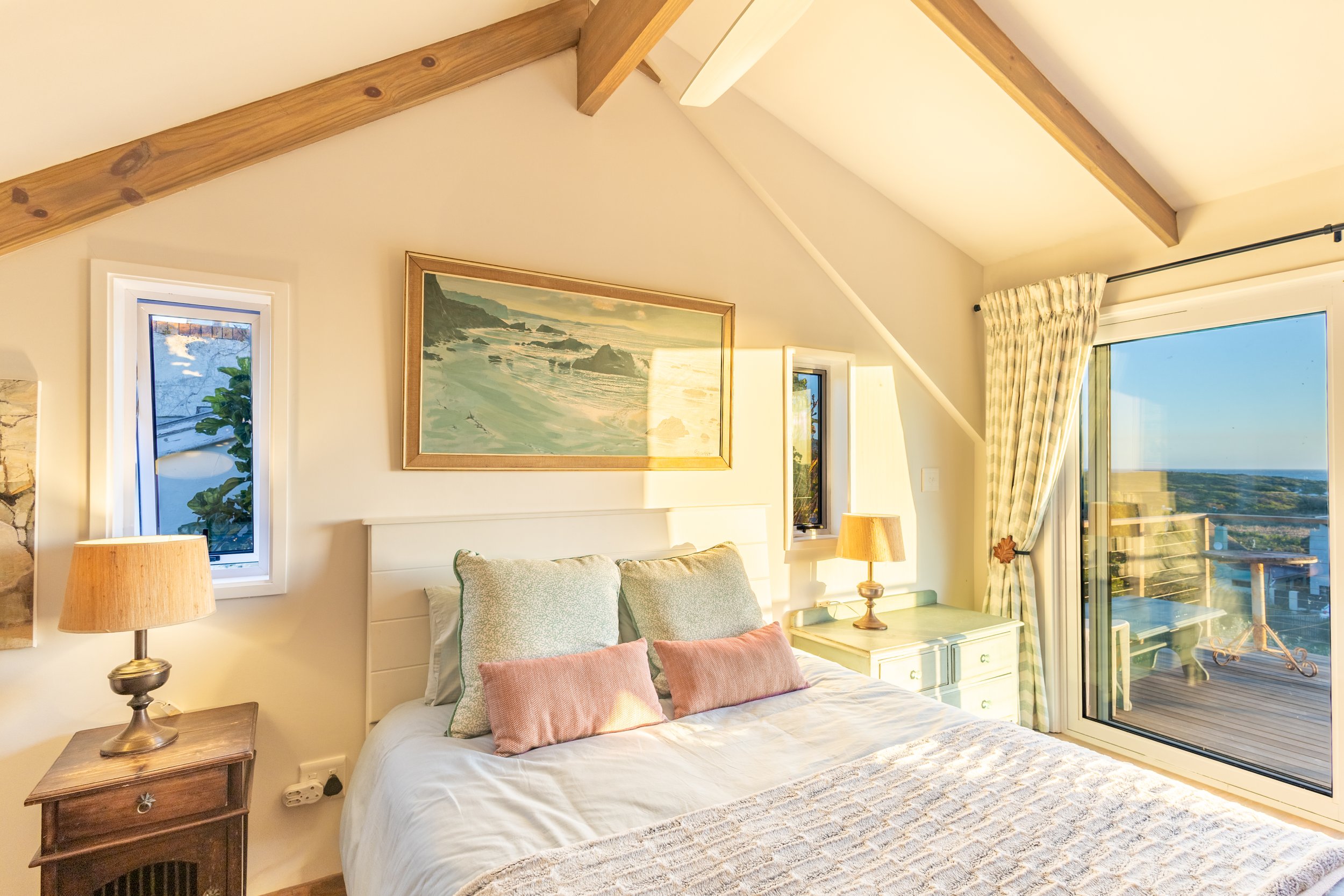 Bright coastal-inspired master bedroom photographed for a luxury holiday home in Cape Town's Deep South.