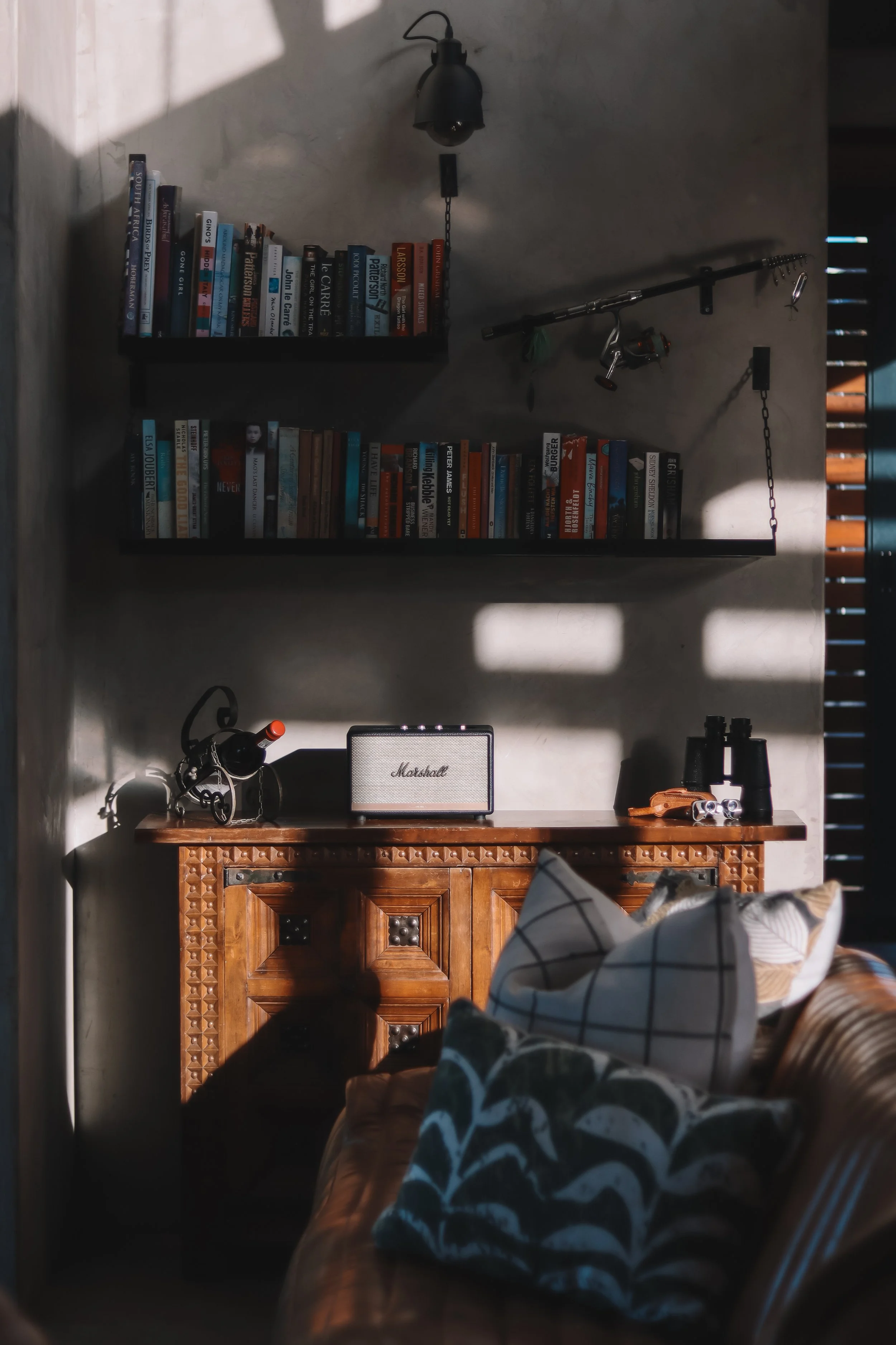 Luxury hospitality interior at Hide Montagu featuring a cozy reading nook with a vintage radio, binoculars, and wine, showcasing the lifestyle experience.