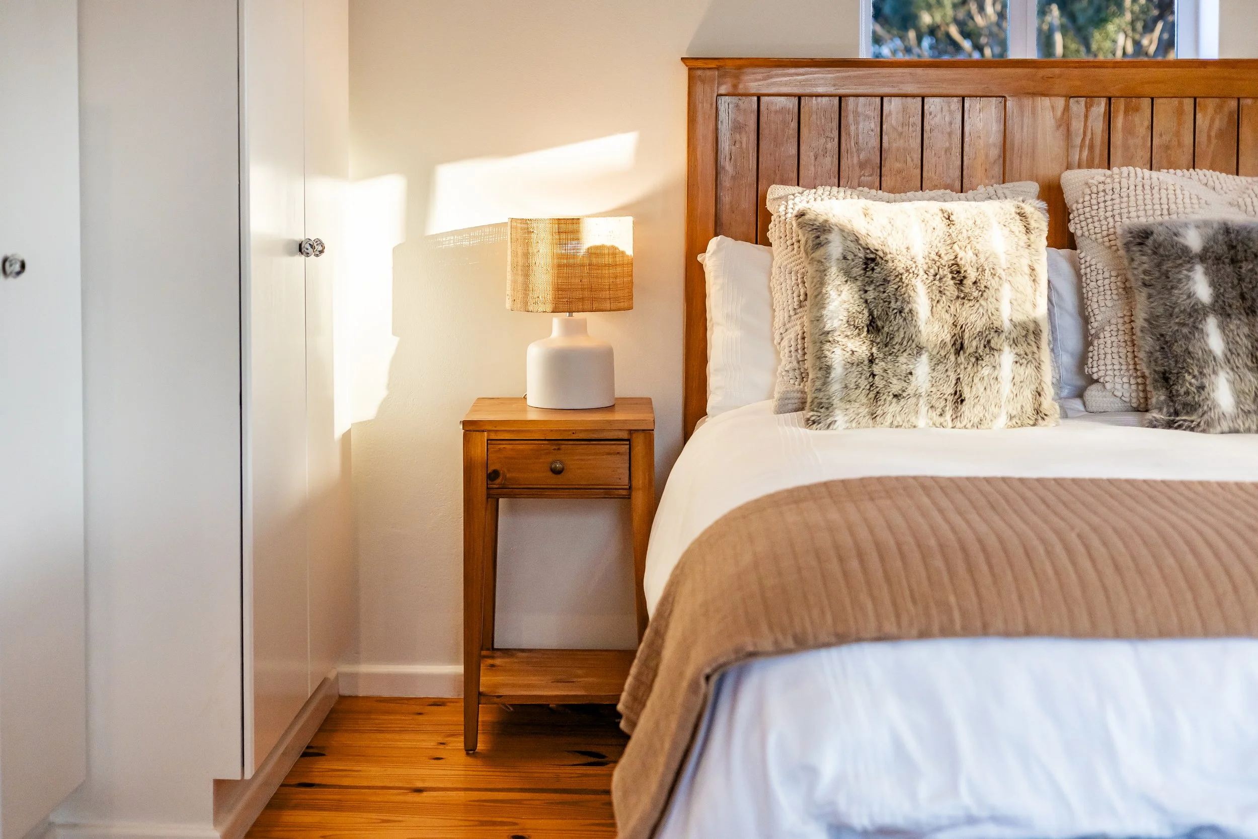 Comfortable guest bedroom with warm natural light photographed for a luxury Airbnb accommodation in Cape Town.