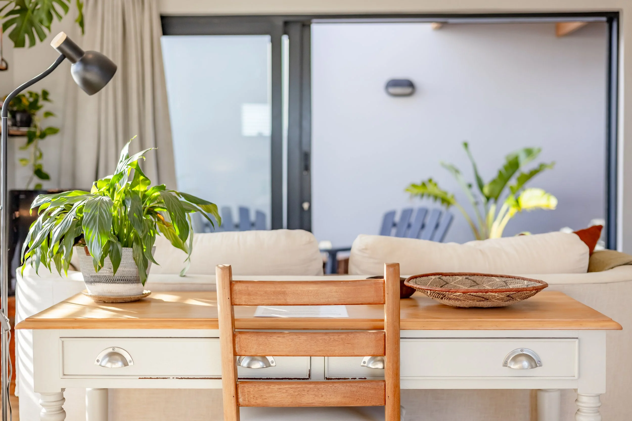 Bright breakfast nook overlooking a private courtyard photographed for a modern Airbnb property in Cape Town's Deep South.