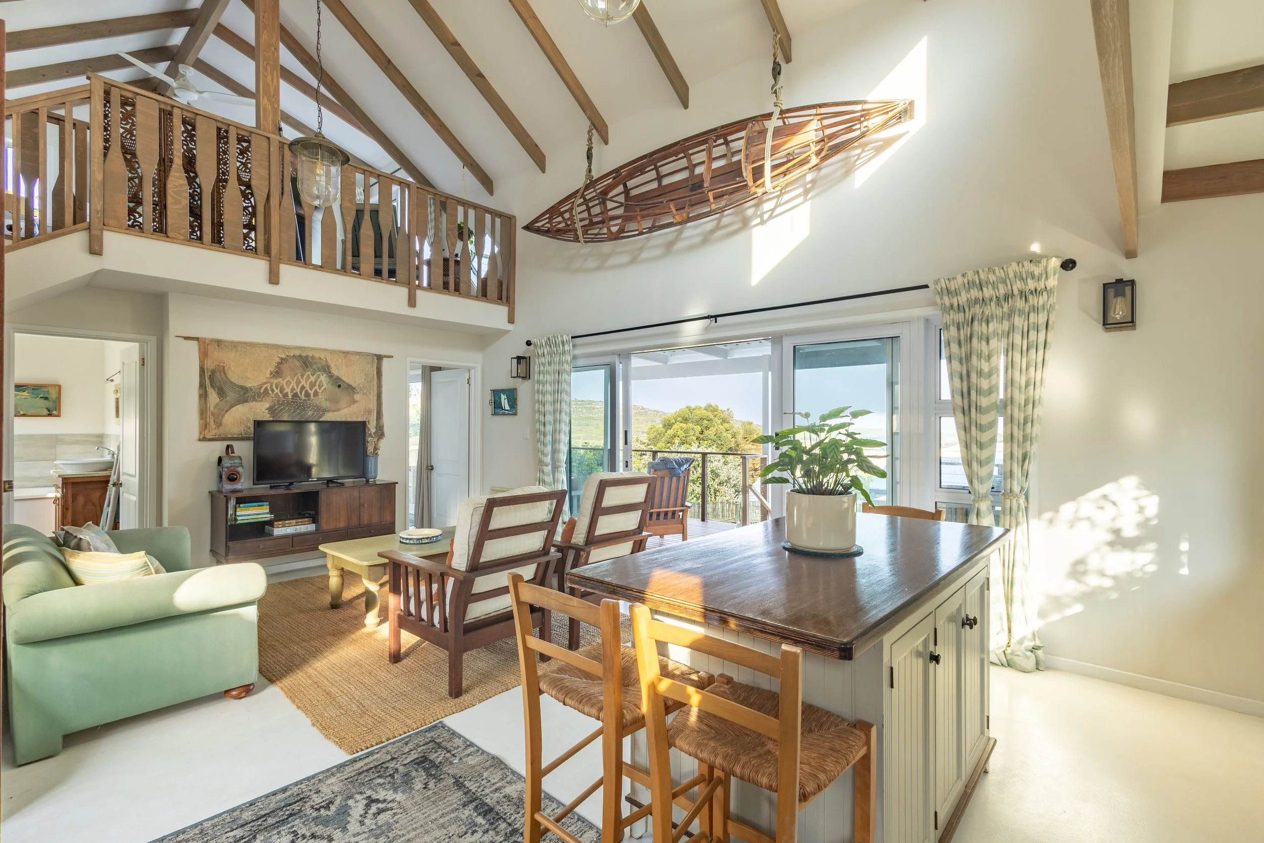 Open-plan kitchen, dining and lounge area photographed for luxury real estate and Airbnb marketing in Cape Town.