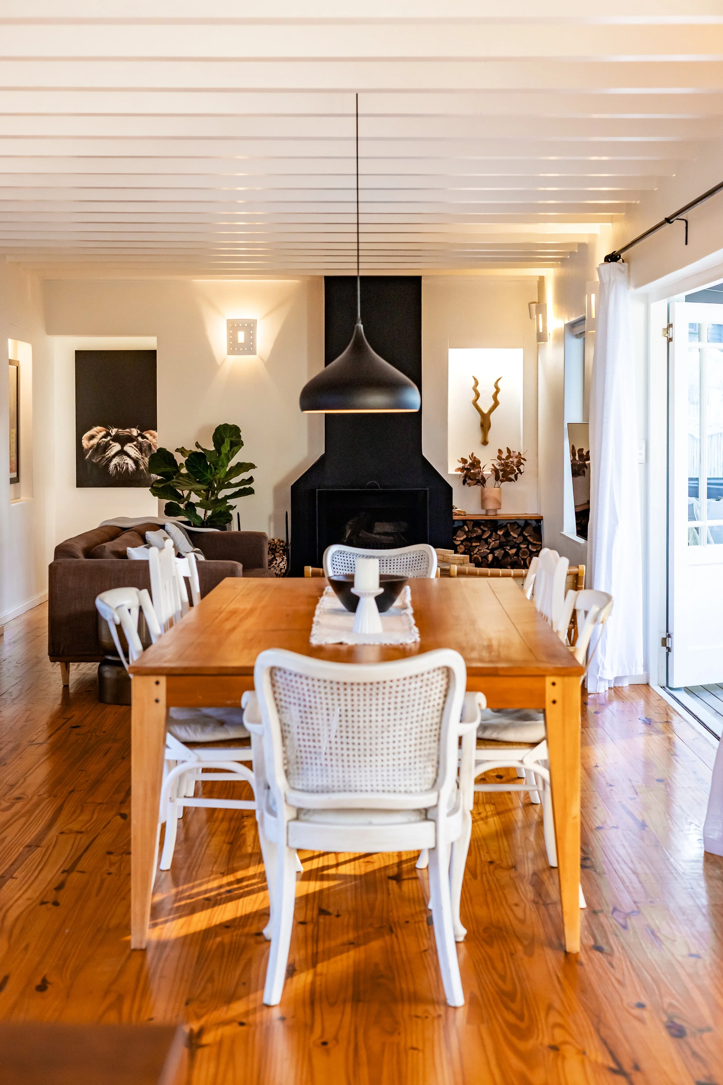 Spacious open-plan dining and living area professionally photographed for an Airbnb and residential property listing.