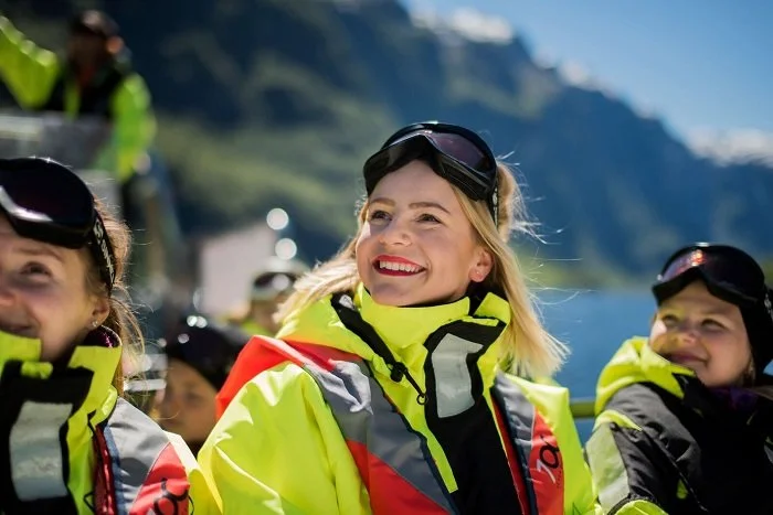 People smiling while on a RIB tour with FjordSafari