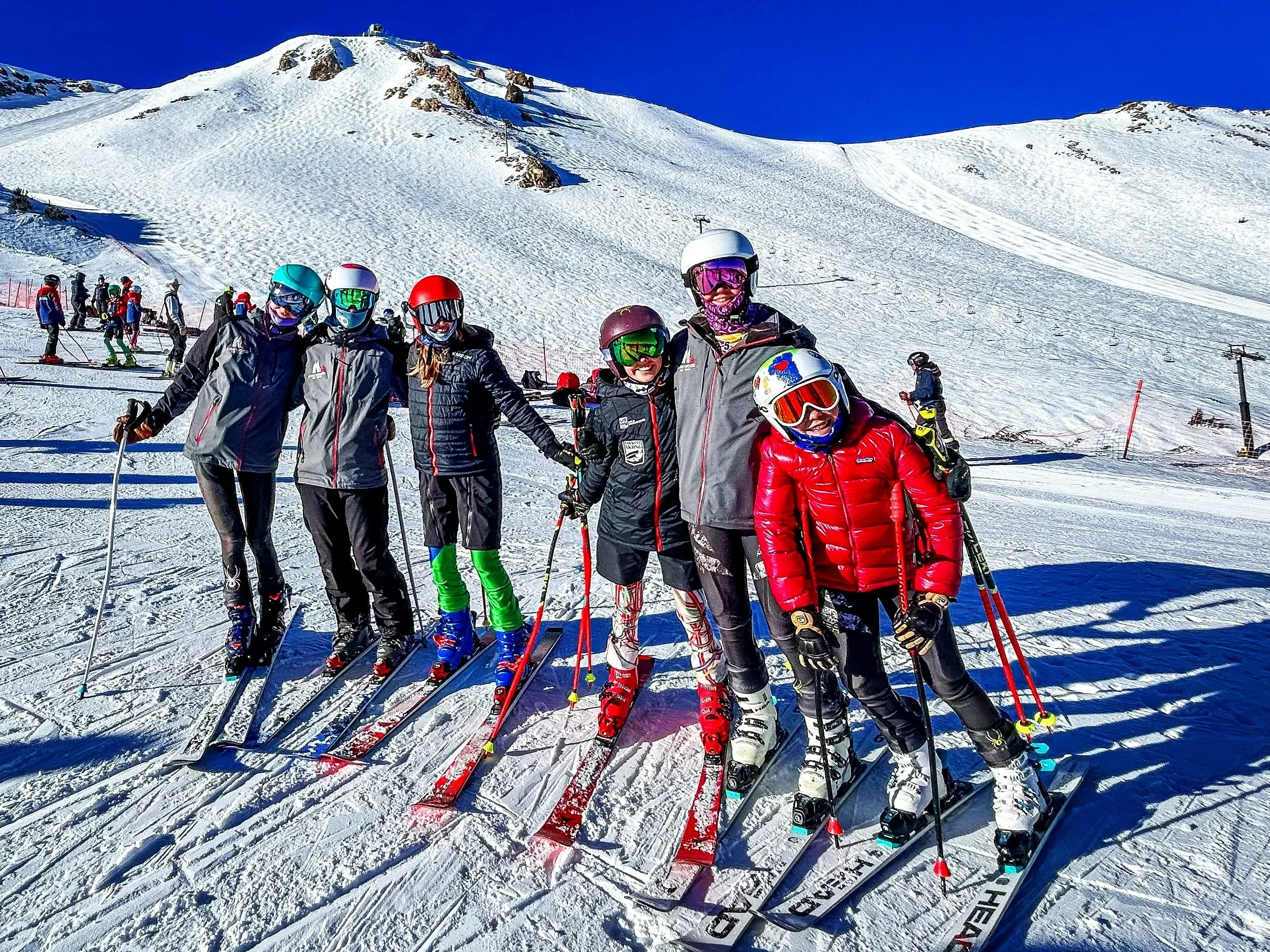 Kirkwood Ski Education Foundation athletes standing on skis beneath Kirkwood’s snowy mountain ridgeline