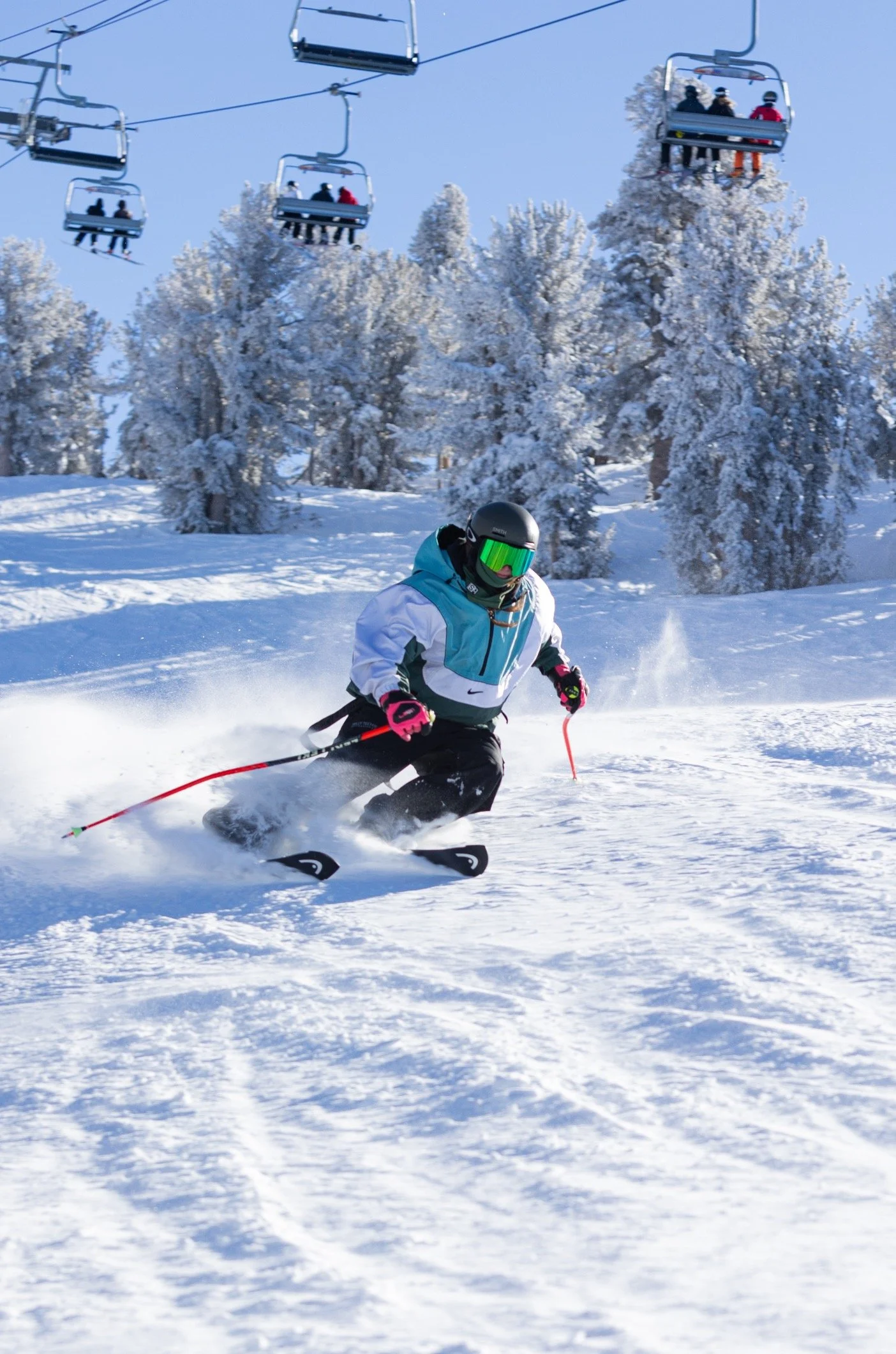 Katarina “Kat” Fenton, KSEF U16 head coach, making a turn on a snowy slope beneath a chairlift