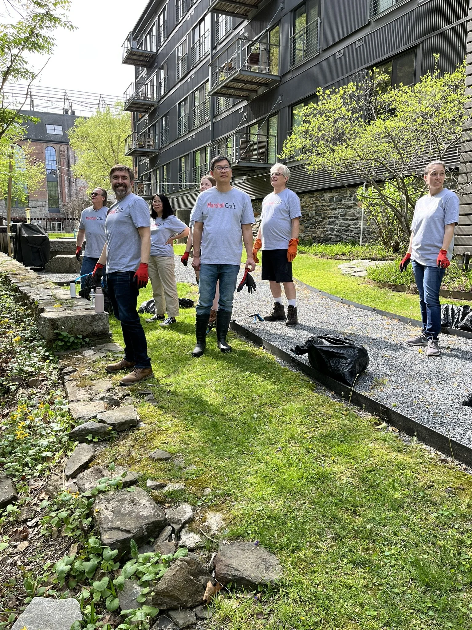 Marshall Craft team participating in a neighborhood clean-up of the Jones Falls stream that surrounds our office in Clipper Mill.