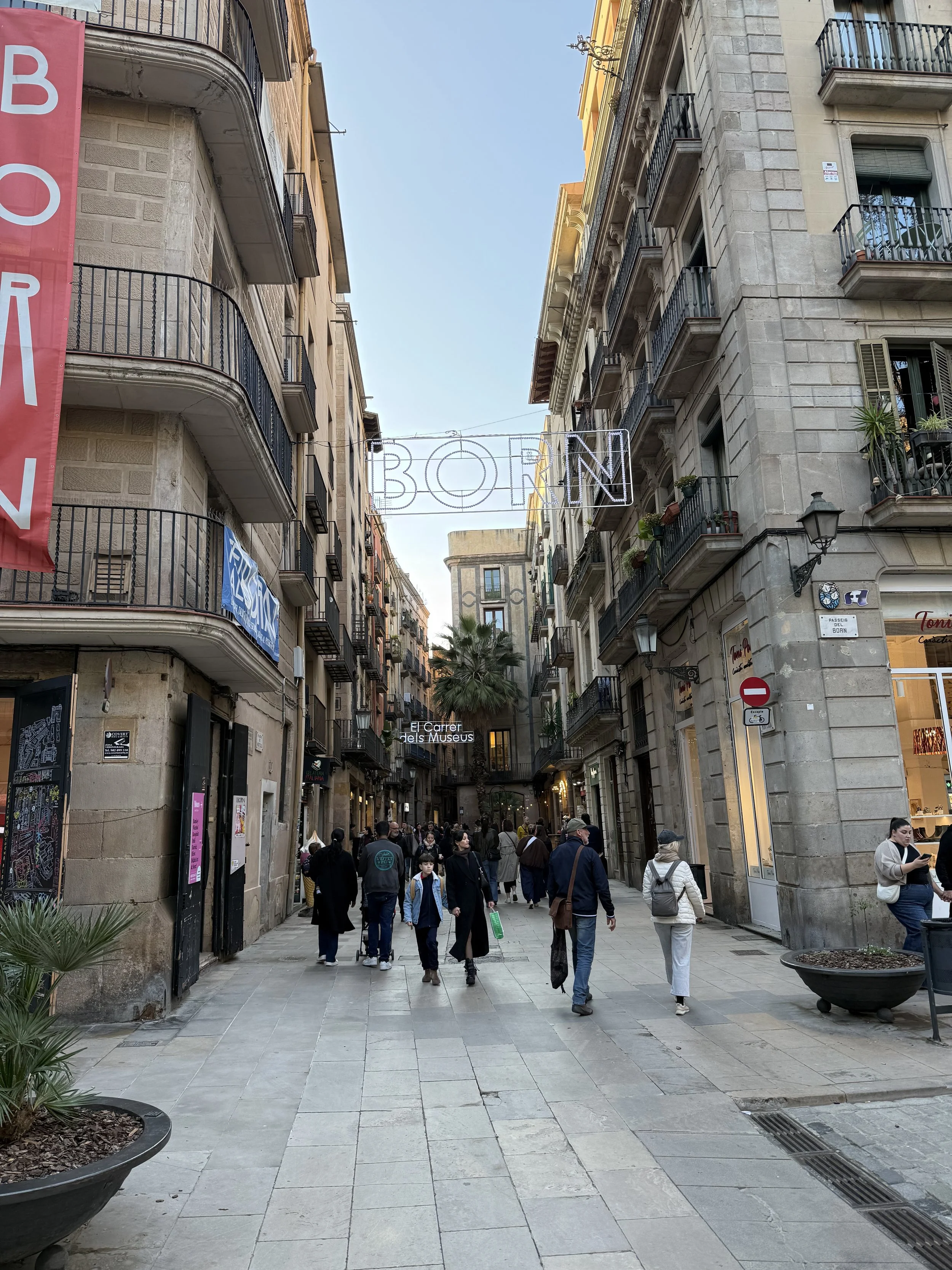 El Born neighborhood street with "Born" sign and traditional Barcelona buildings