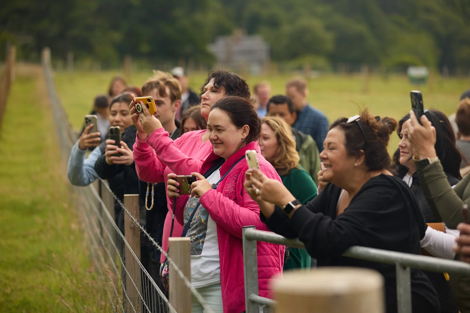 PHONES UP AT THE FENCE