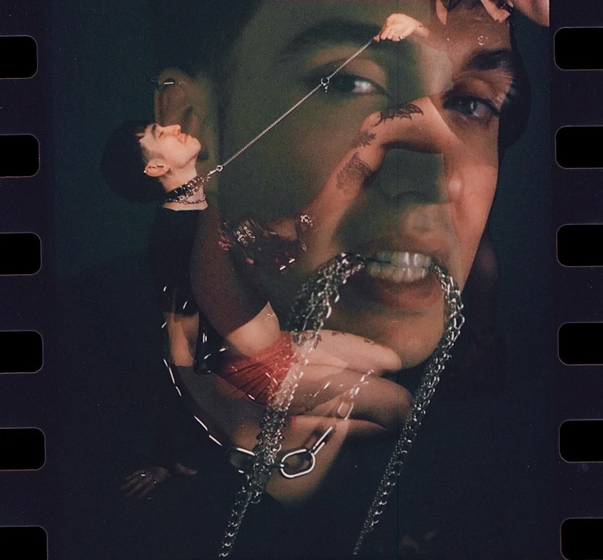 Double exposure of a face with a chain in its mouth and a figure in black leather, on dark film. Dominance by Hartenjager.