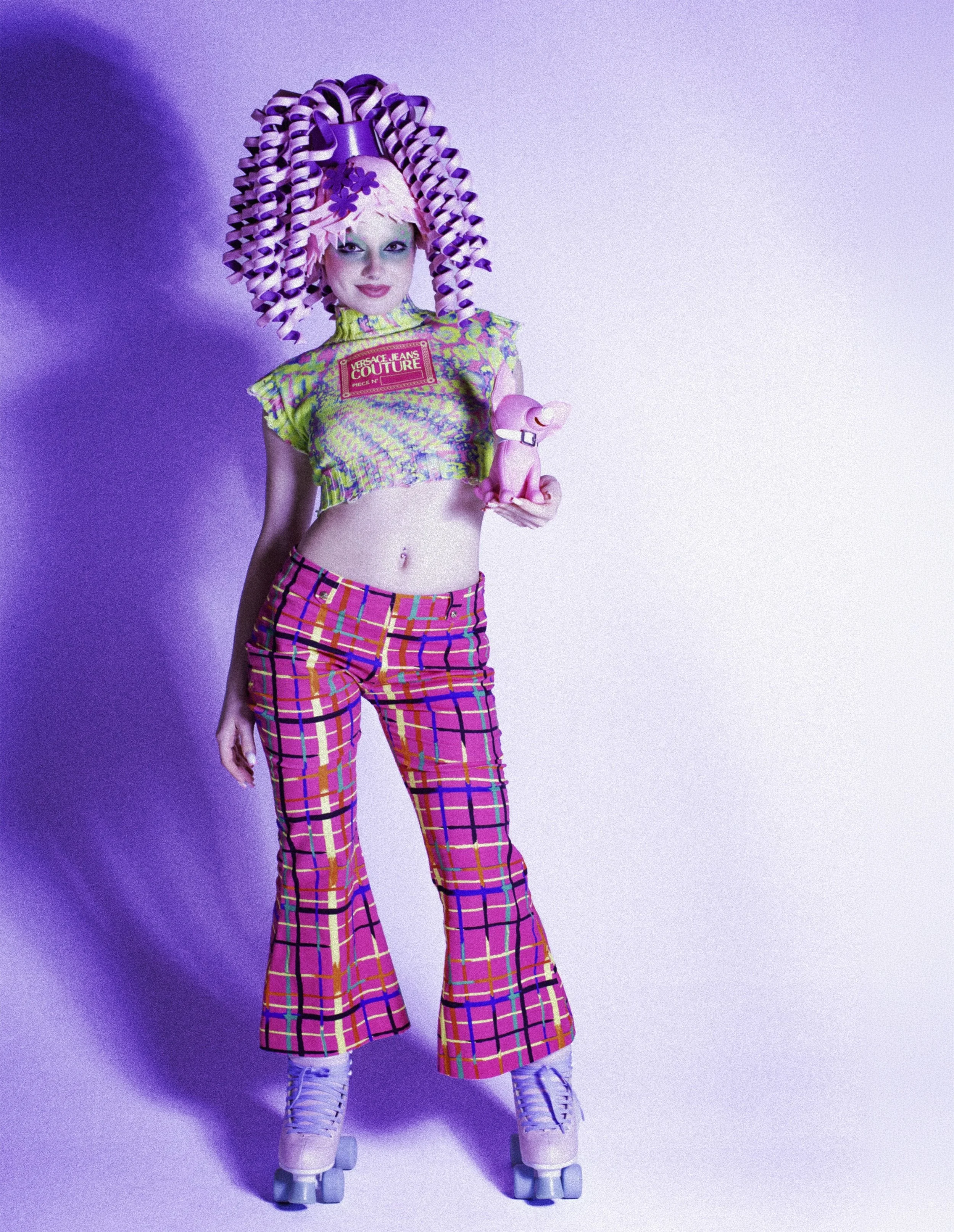 Model in a sculpted purple curl wig, cropped top and pink plaid flares against purple. Loopsyland, editorial for Kaltblut Magazine by Hartenjager.